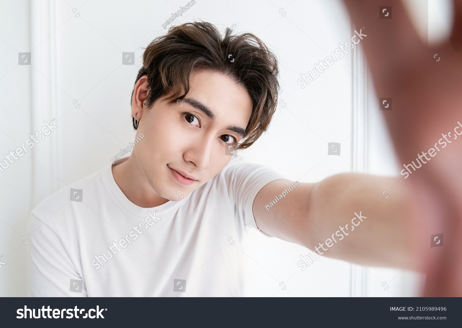 Portrait of young handsome asian man use smartphone selfie say hi over white background. Happy asian guy online influencer blogger. Education technology connected people man lifestyle concept #2105989496