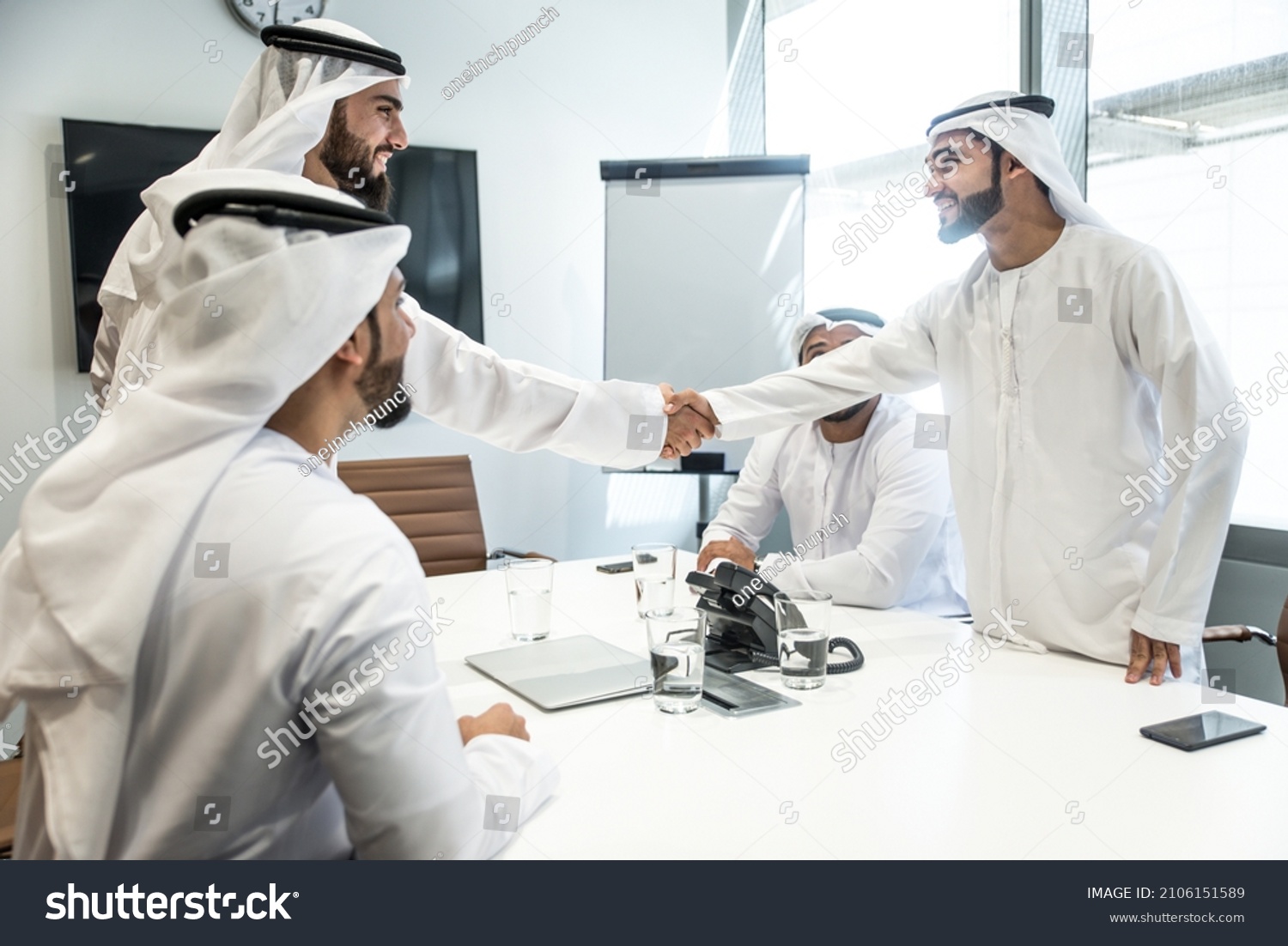 Group of business managers from the emirates meeting and working together in Dubai. Arabian businessmen wearing traditional clothes #2106151589