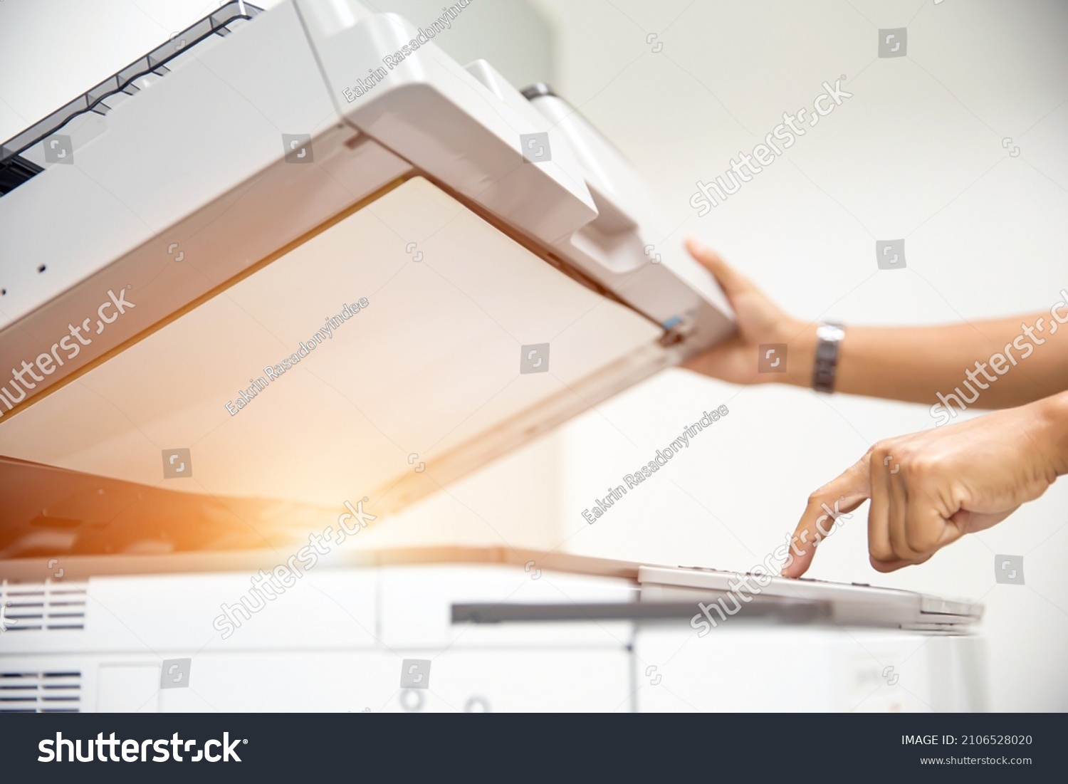 Copier printer, Close up hand office man press copy button on panel to using the copier or photocopier machine for scanning document printing a sheet paper and xerox photocopy. #2106528020