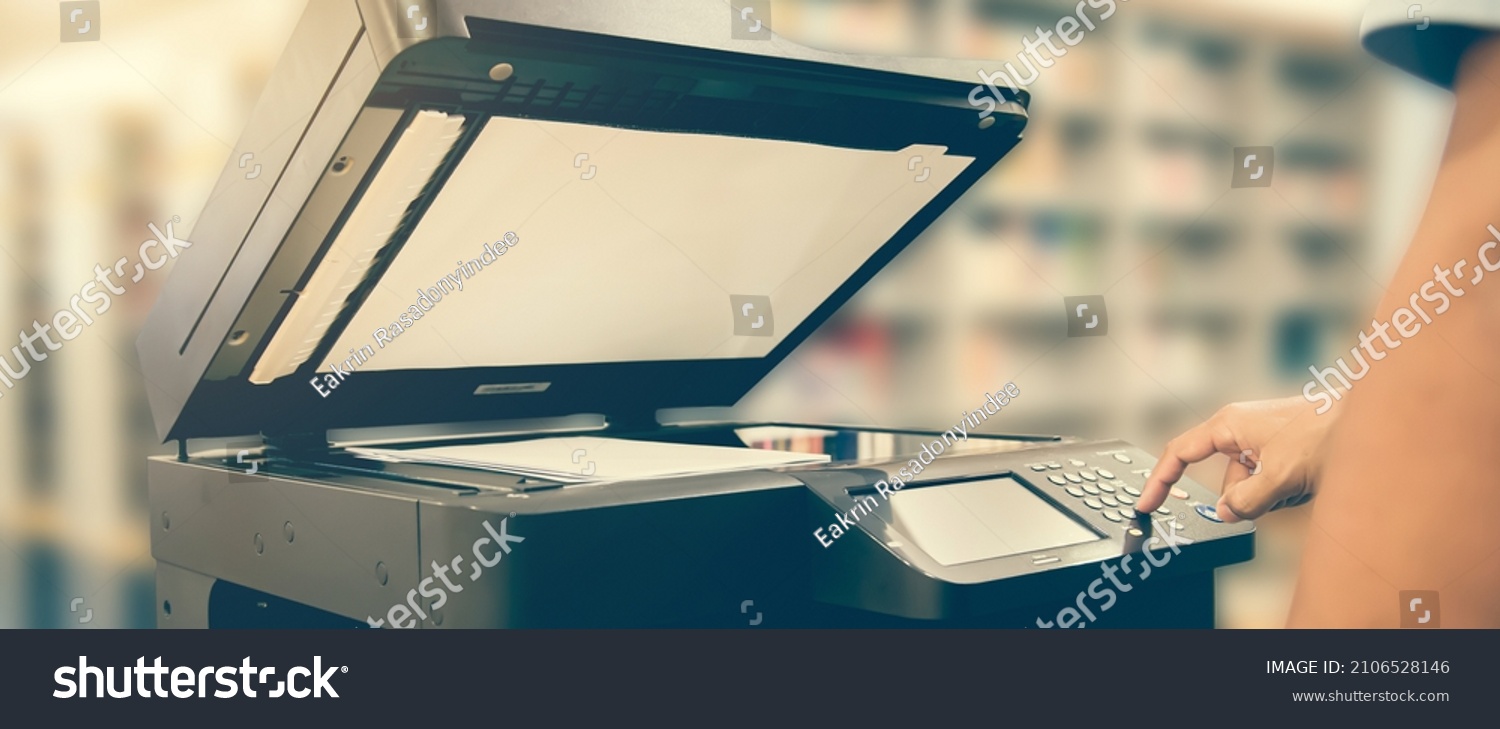 Copier printer, Close up hand office man press copy button on panel to using the copier or photocopier machine for scanning document printing a sheet paper and xerox photocopy. #2106528146