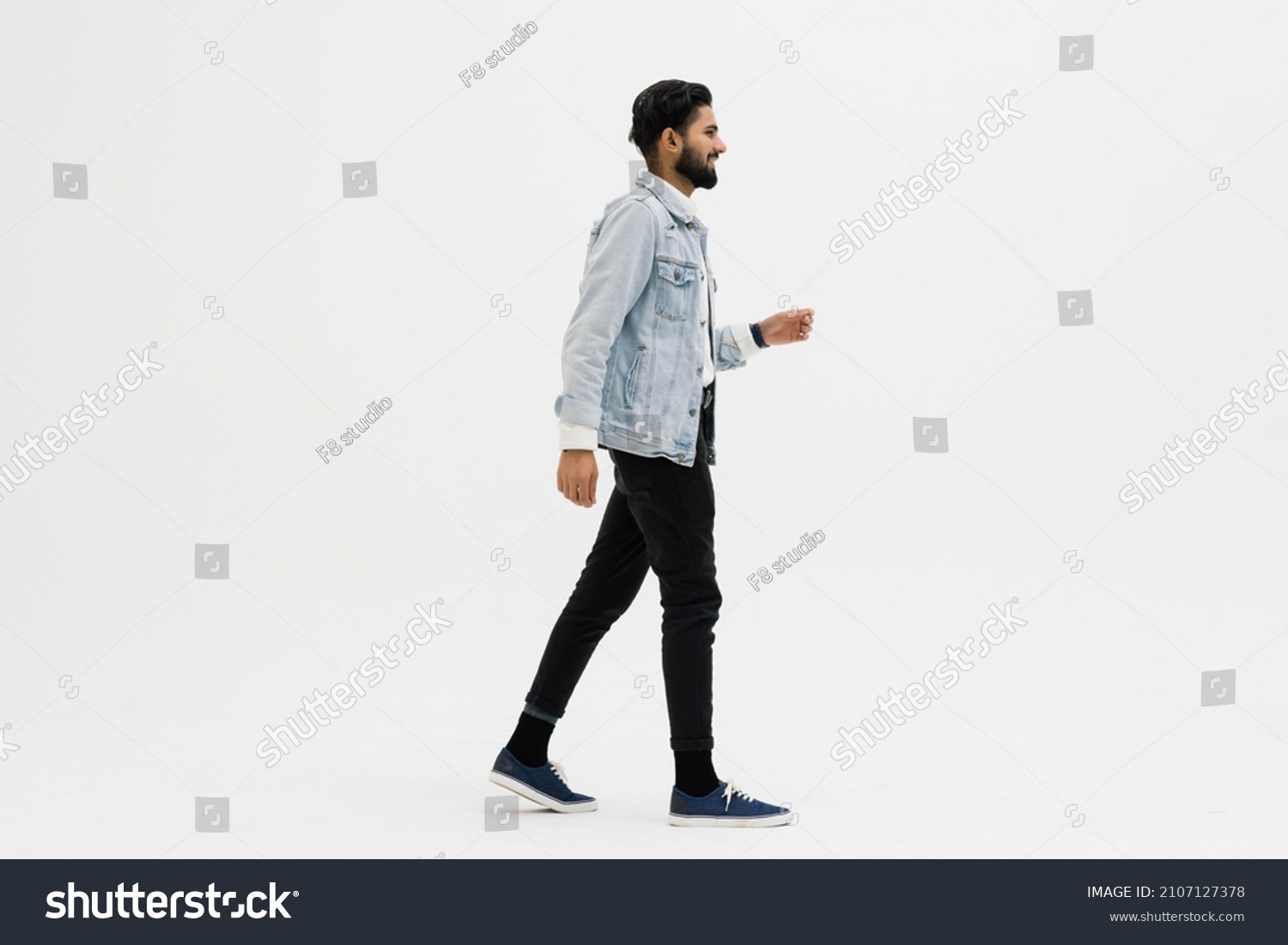 Full length side shot of handsome beard man walking, isolated on white background #2107127378