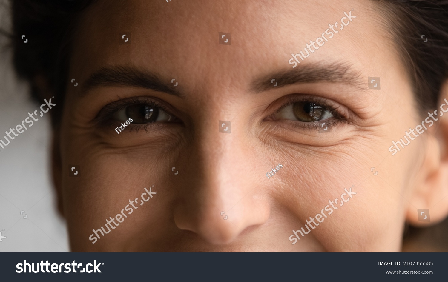 Extreme close up happy young hispanic caucasian woman with brown eyes looking at camera. Smiling millennial female client feeling satisfied with ophthalmology clinic service, eyesight laser correction #2107355585