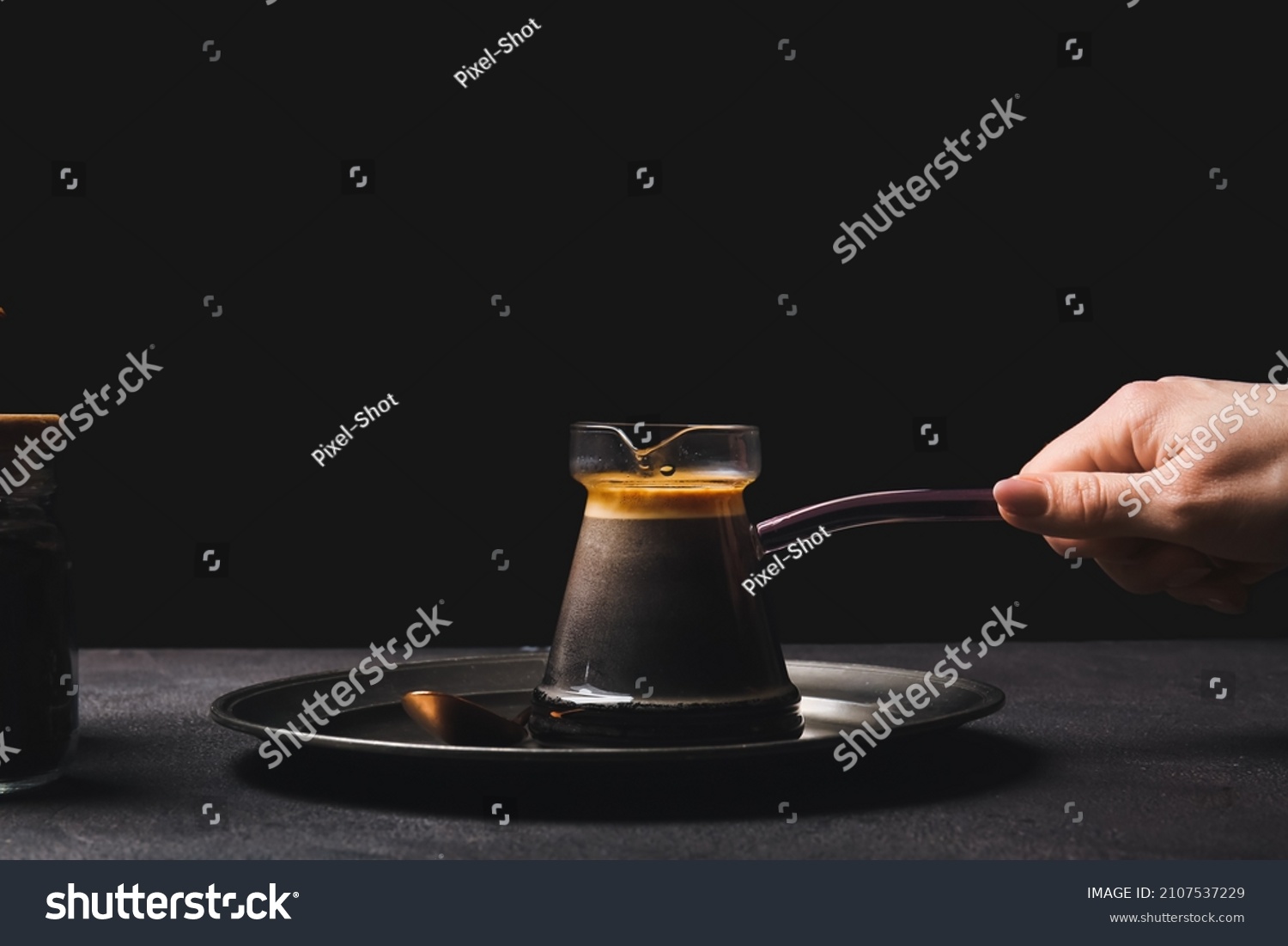 Woman with delicious turkish coffee in cezve on dark background #2107537229