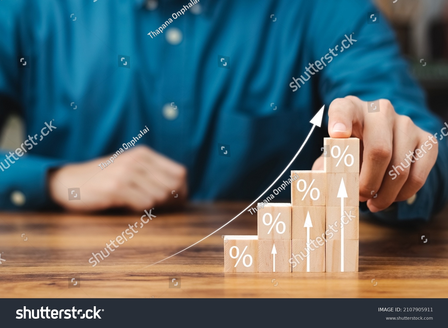 Interest rate and dividend concept, wooden block with percentage symbol and up arrow, return on stocks and mutual funds, long term investment for retirement. #2107905911