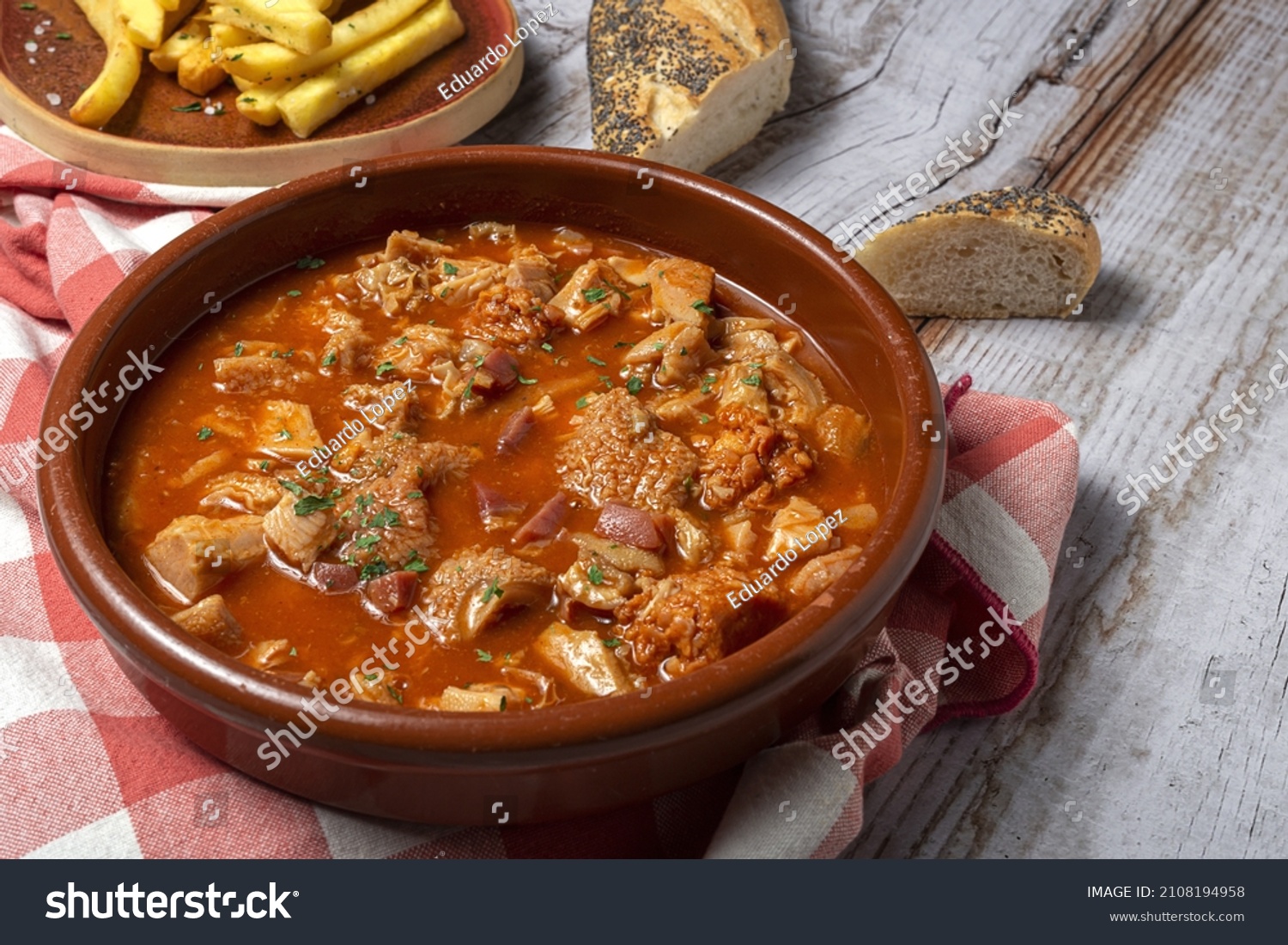 Traditional homemade rabbit meat stew with red wine sauce with aromatic herbs on a black background #2108194958
