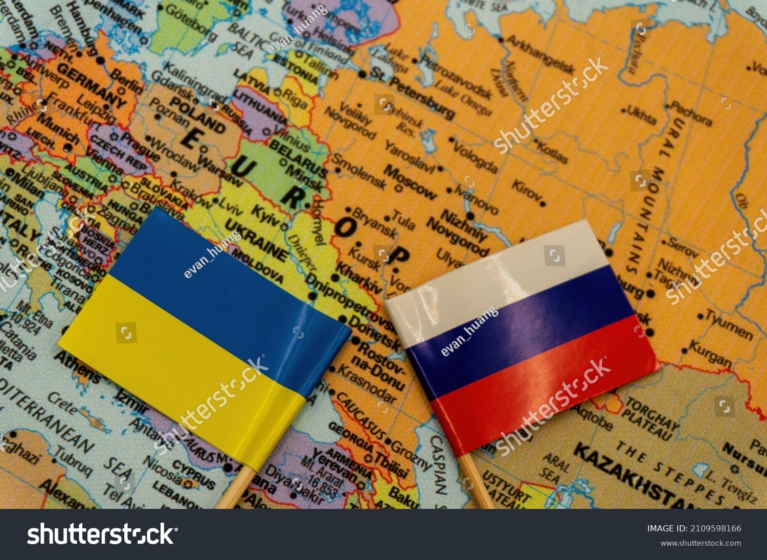 The Ukrainian and Russian flags are placed on a map of Europe.selective focus on the smaller flags top. International situation theme #2109598166