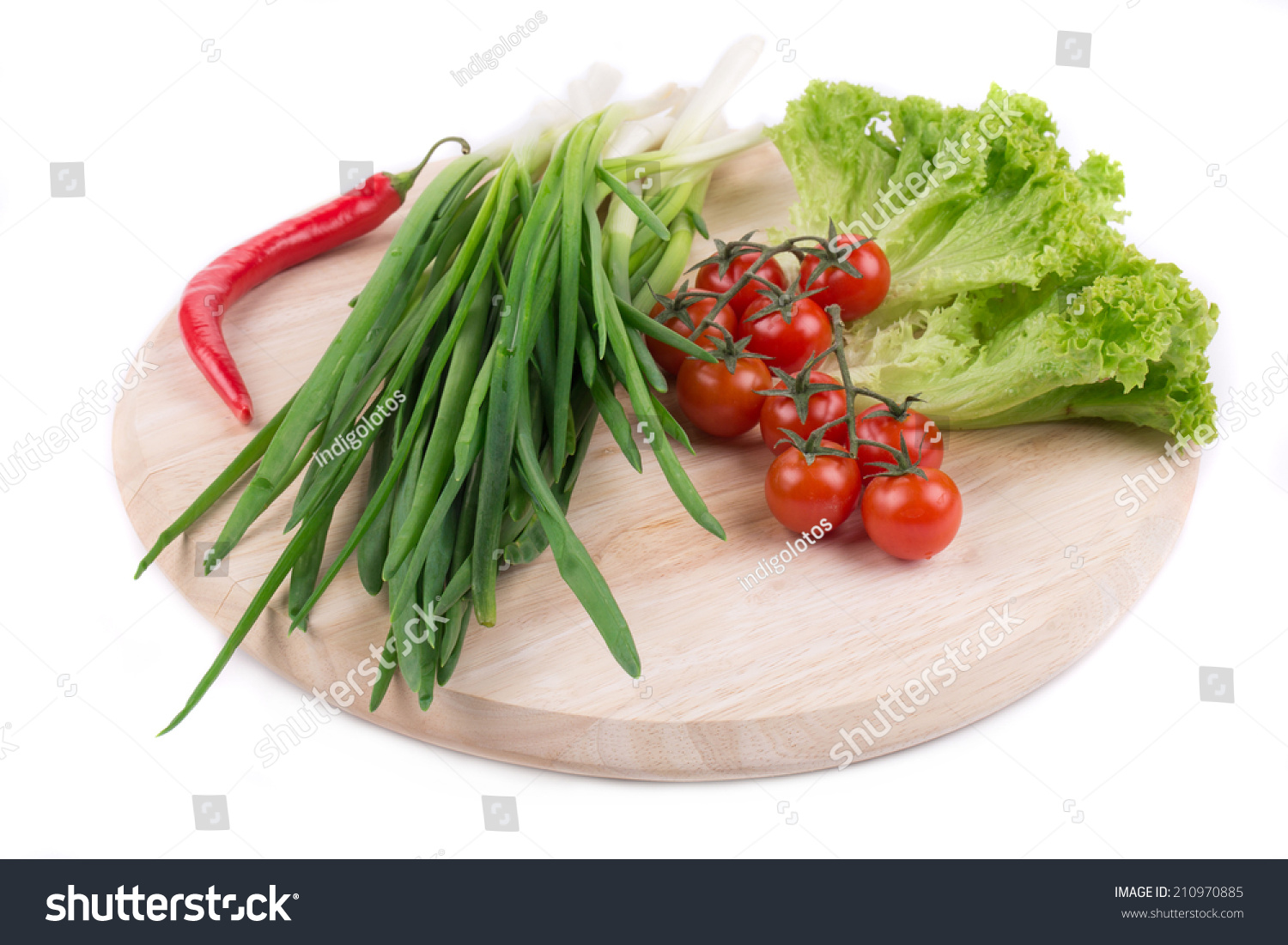 Onions and cherry tomatoes on a wooden board. #210970885
