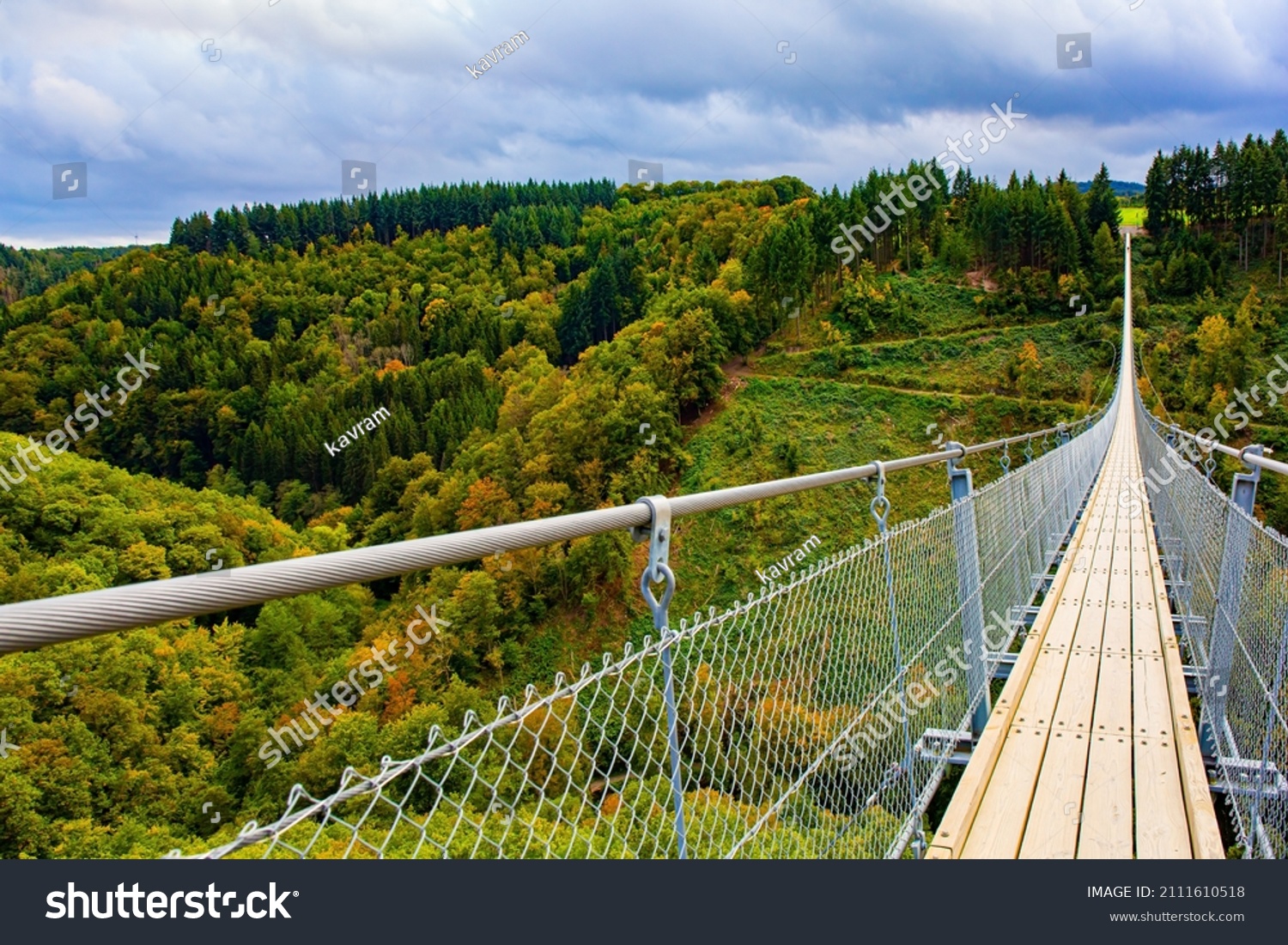 Geierlay- cableway suspension bridge in Germany. Hunsrück region in Rhineland-Palatinate. Picturesque bridge over the valley of the Mersdorf stream. Windy and cold autumn day #2111610518