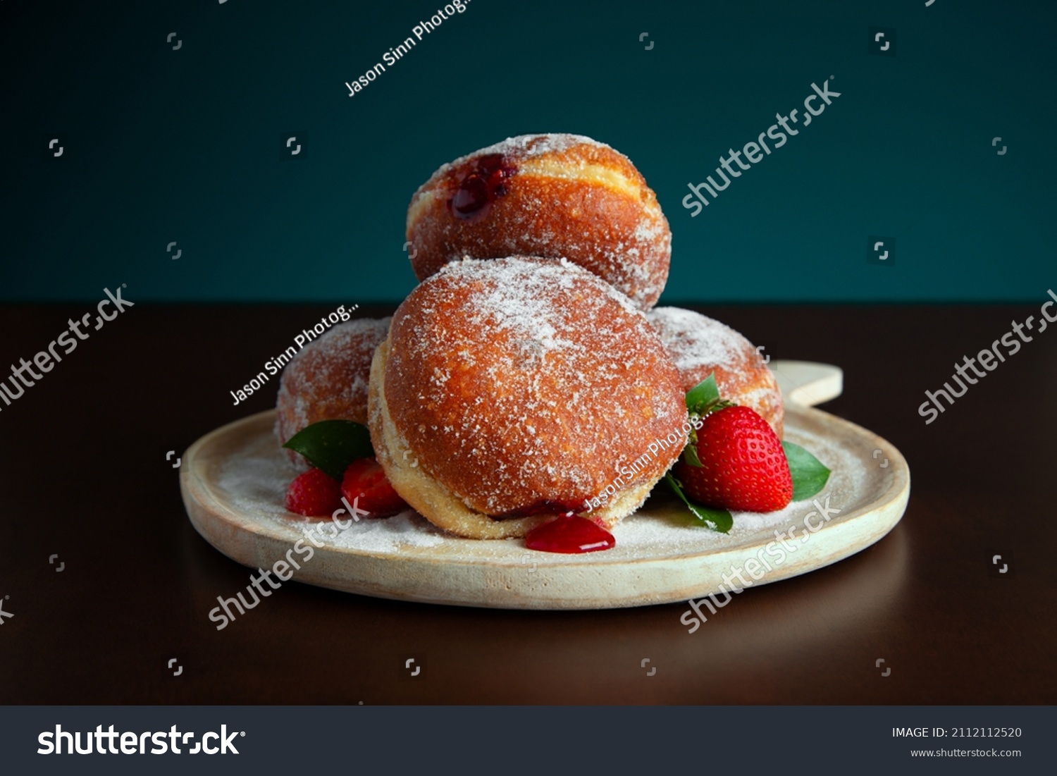 Fresh baked strawberry fruit jam filled donuts with a sugar glaze.  #2112112520