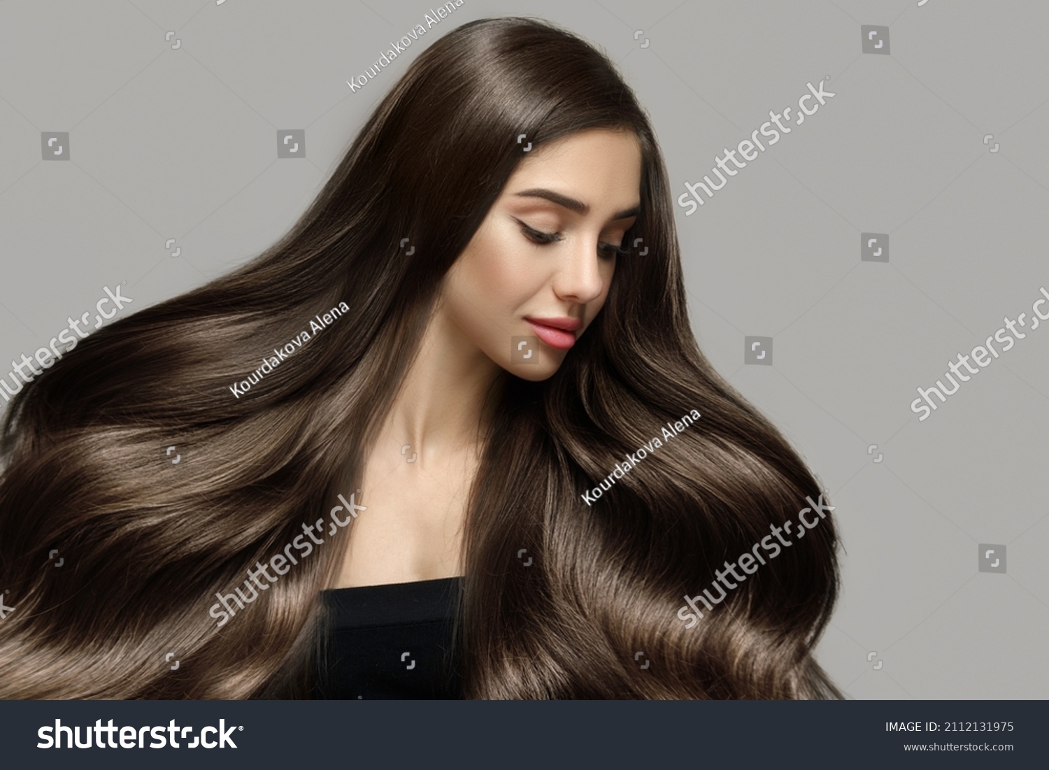 Long beautiful wavy hair. Portrait of a woman with shiny blond hair. copycpase #2112131975
