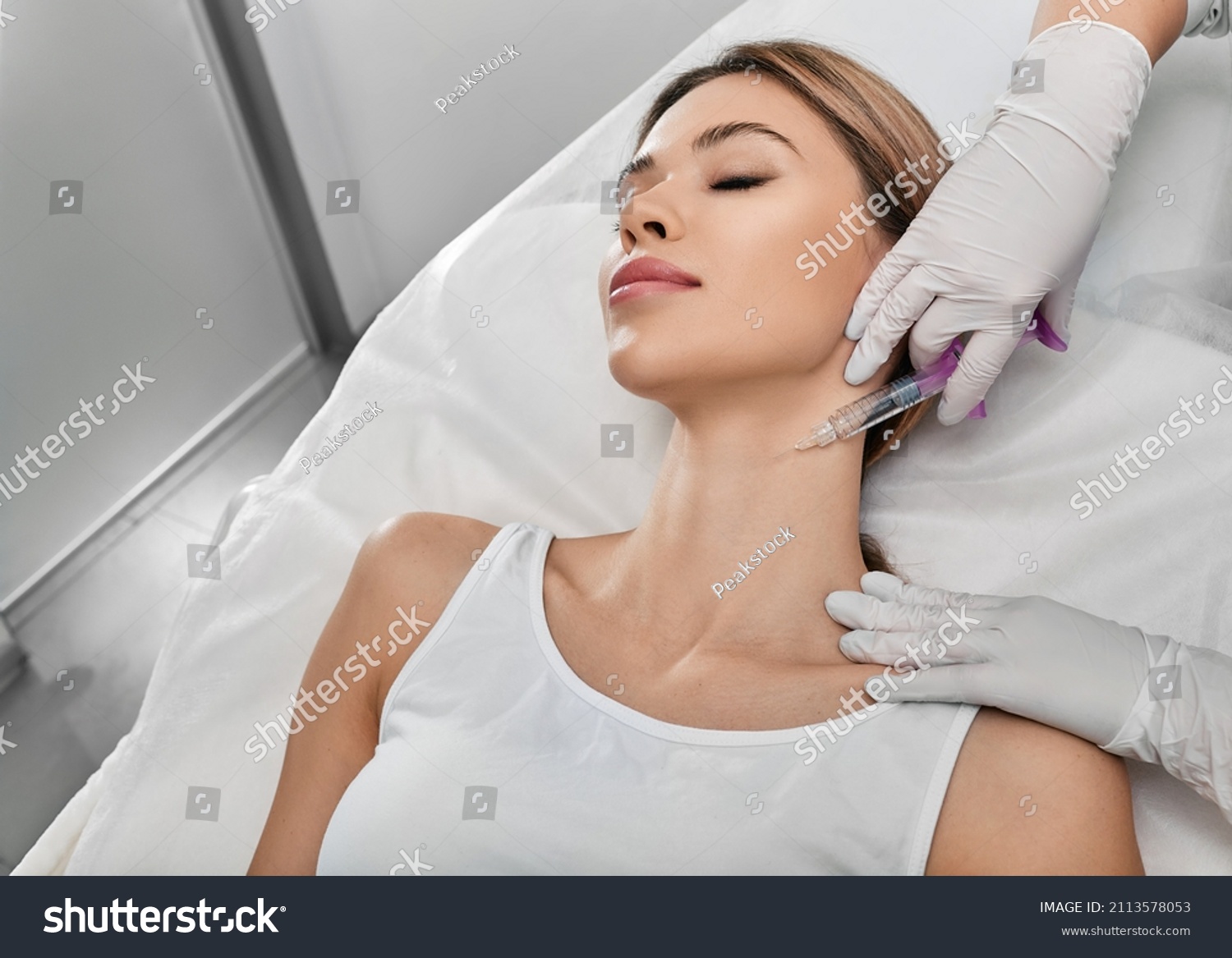 Smoothing female neck skin with injections in neck at cosmetic clinic. Neck skin rejuvenation and contouring, mesotherapy and biorevitalization #2113578053