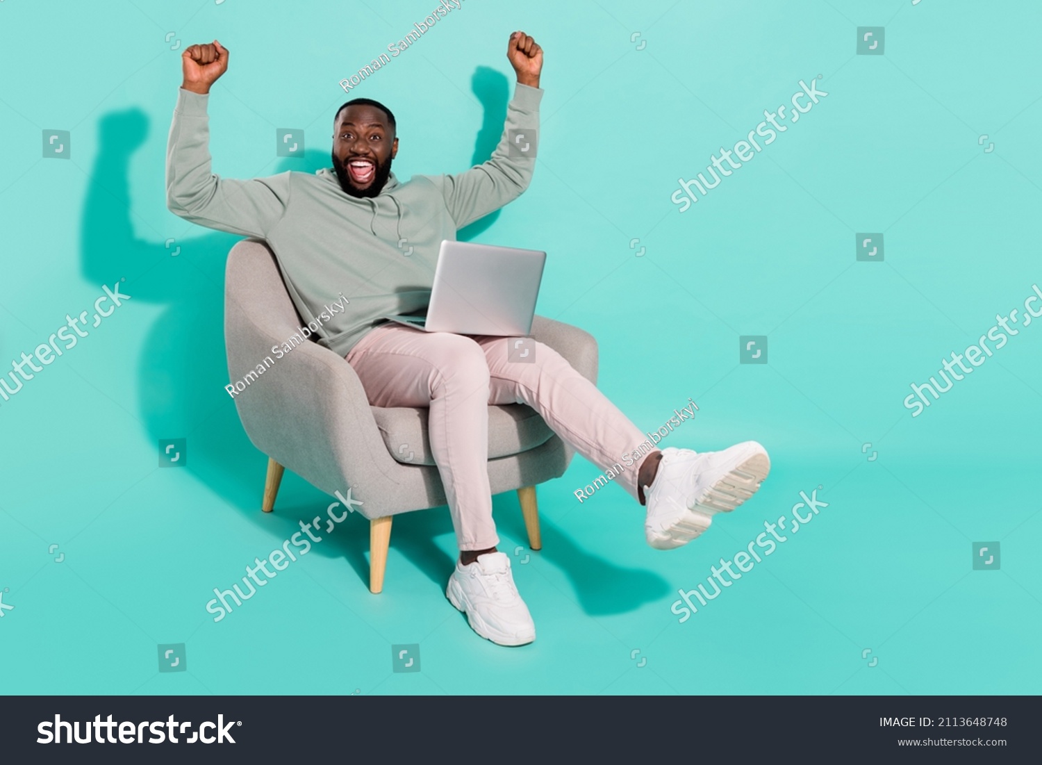 Full length body size view of handsome trendy cheery lucky guy using laptop rejoicing isolated over vivid teal turquoise color background #2113648748