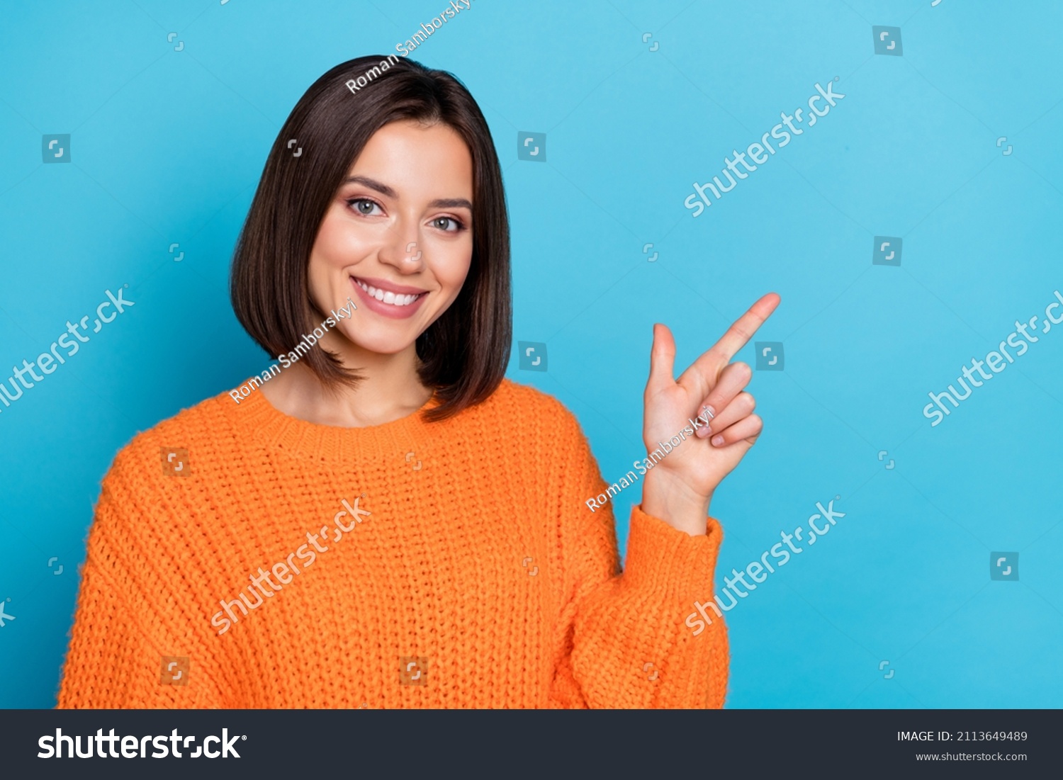 Portrait of attractive cheerful girl demonstrating copy empty space ad advert isolated over bright blue color background #2113649489