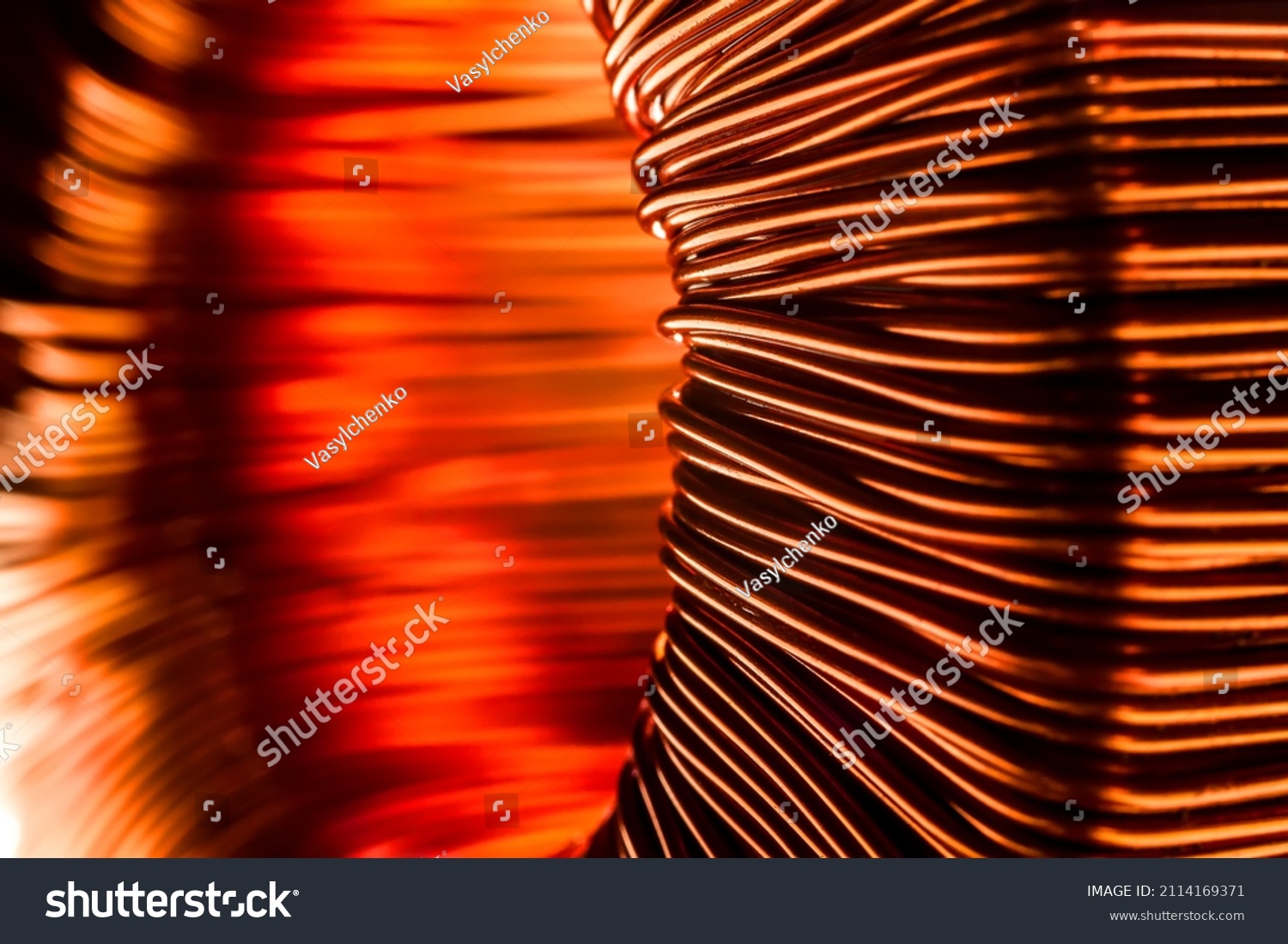 Copper wire coil. Toroidal transformer close-up. Bright image of copper. A selective focus. #2114169371