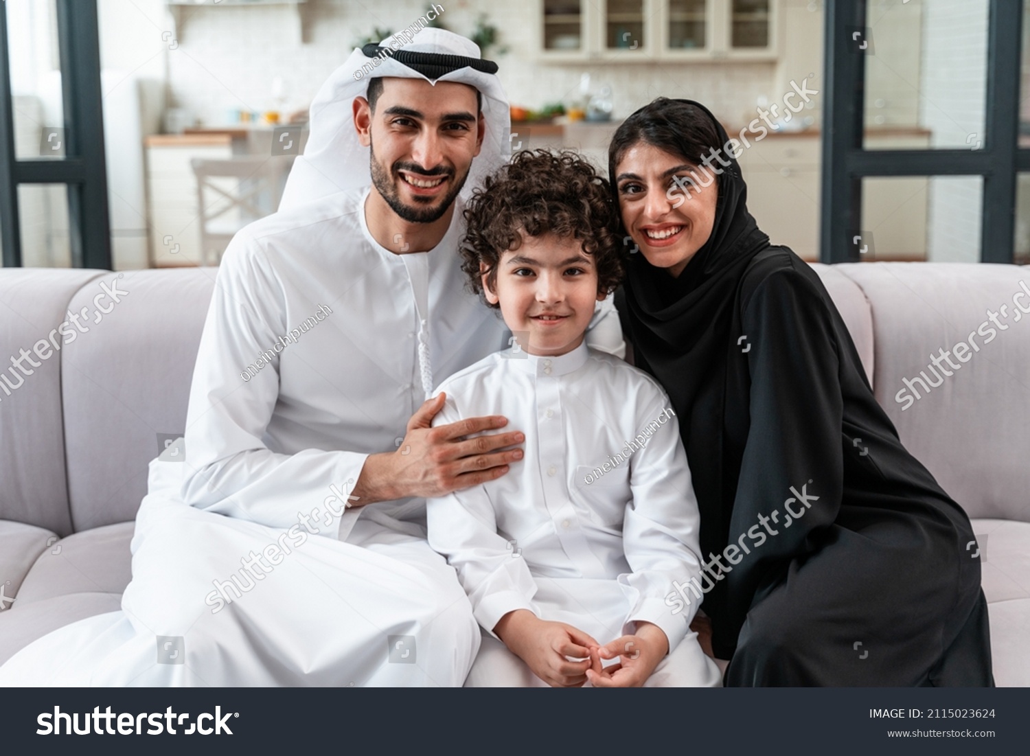 happy family spending time together. Arabian parents and their son playing and making different activities at home #2115023624