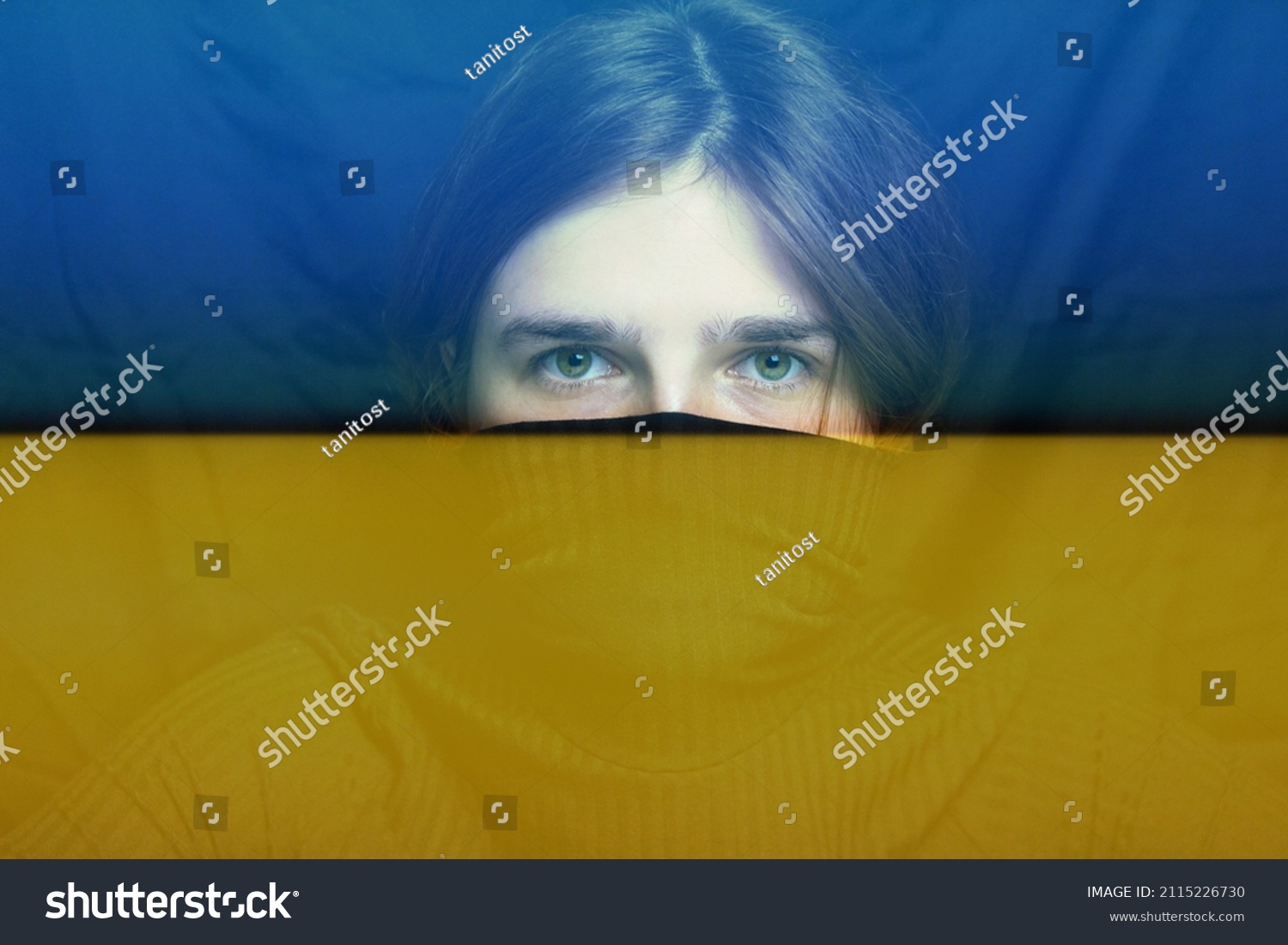War between Russia and Ukraine. Young woman with sad sight looking at camera. Art portrait. Mental health concept. Face of depression. Caucasian woman with green eyes on black background. #2115226730