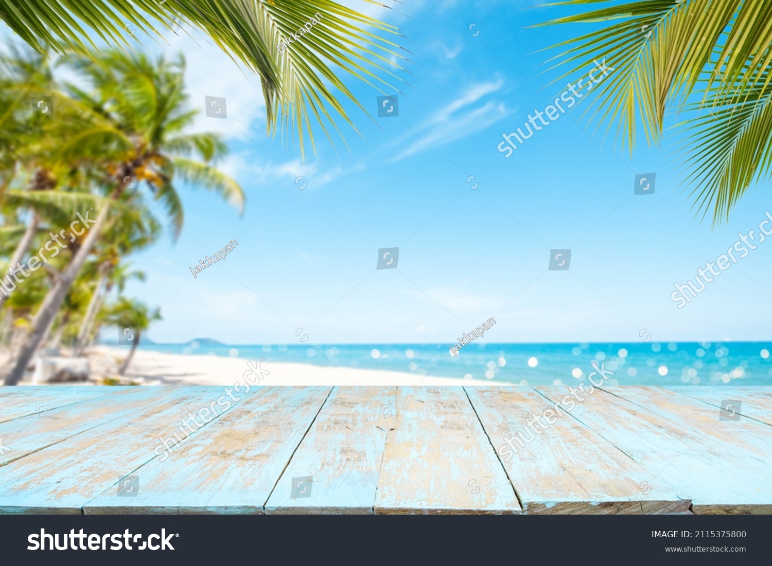 Top of wood table with seascape and palm tree, blur bokeh light of calm sea and sky at tropical beach background. Empty ready for your product display montage. summer vacation background concept. #2115375800