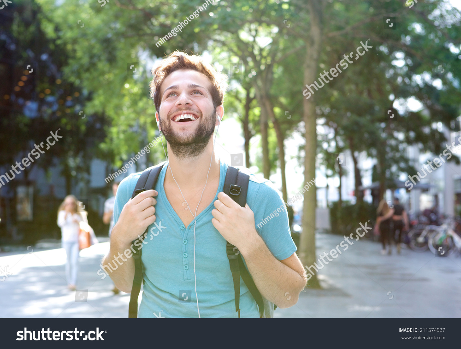 Close up portrait of a handsome young man walking outdoors with backpack #211574527