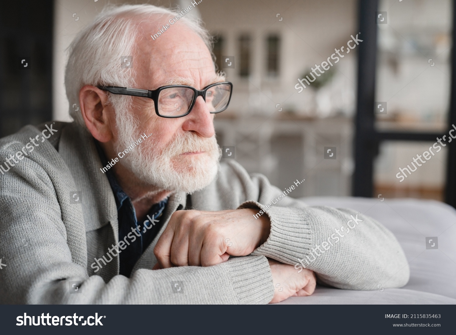 Lonely missing old people, senior man elderly grandfather sitting on the sofa, feeling pain, sick, ill, nostalgy, fraud, bankruptcy at home alone, needing help. #2115835463