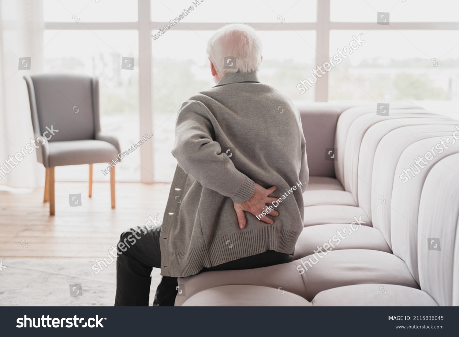 Senior old elderly man grandfather touching his back, suffering from backpain, sciatica, sedentary lifestyle concept. Spine health problems. Healthcare, insurance #2115836045
