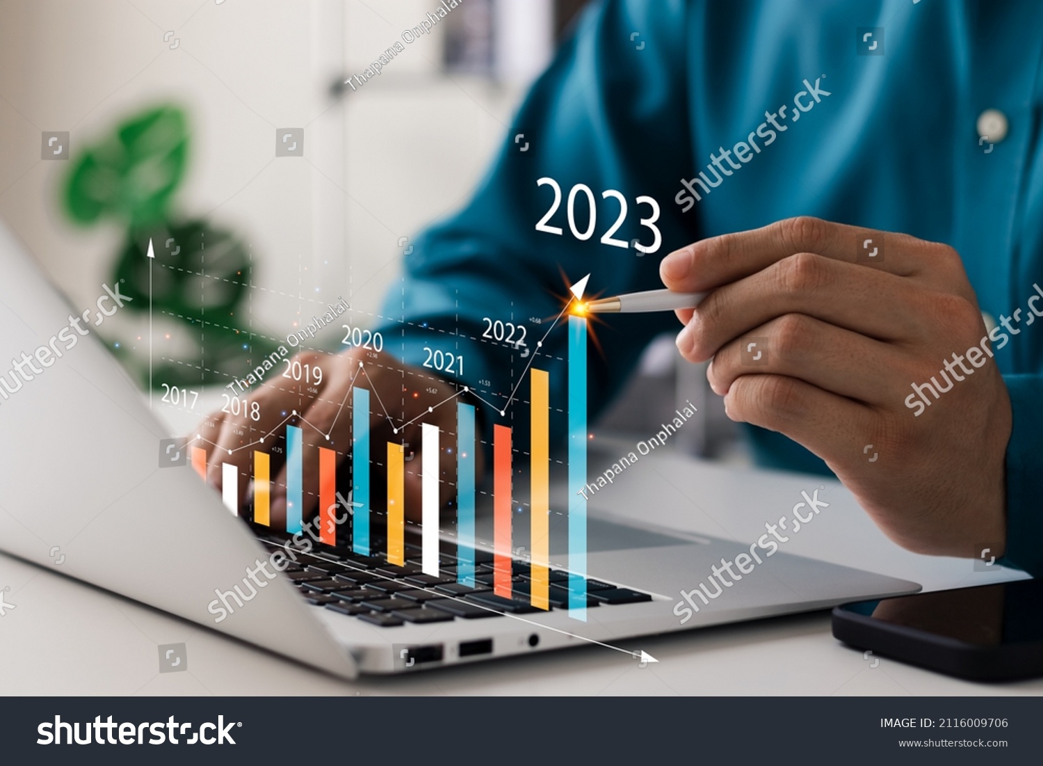 Businessman analyzes profitability of working companies with digital augmented reality graphics, positive indicators in 2023, businessman calculates financial data for long-term investments. #2116009706