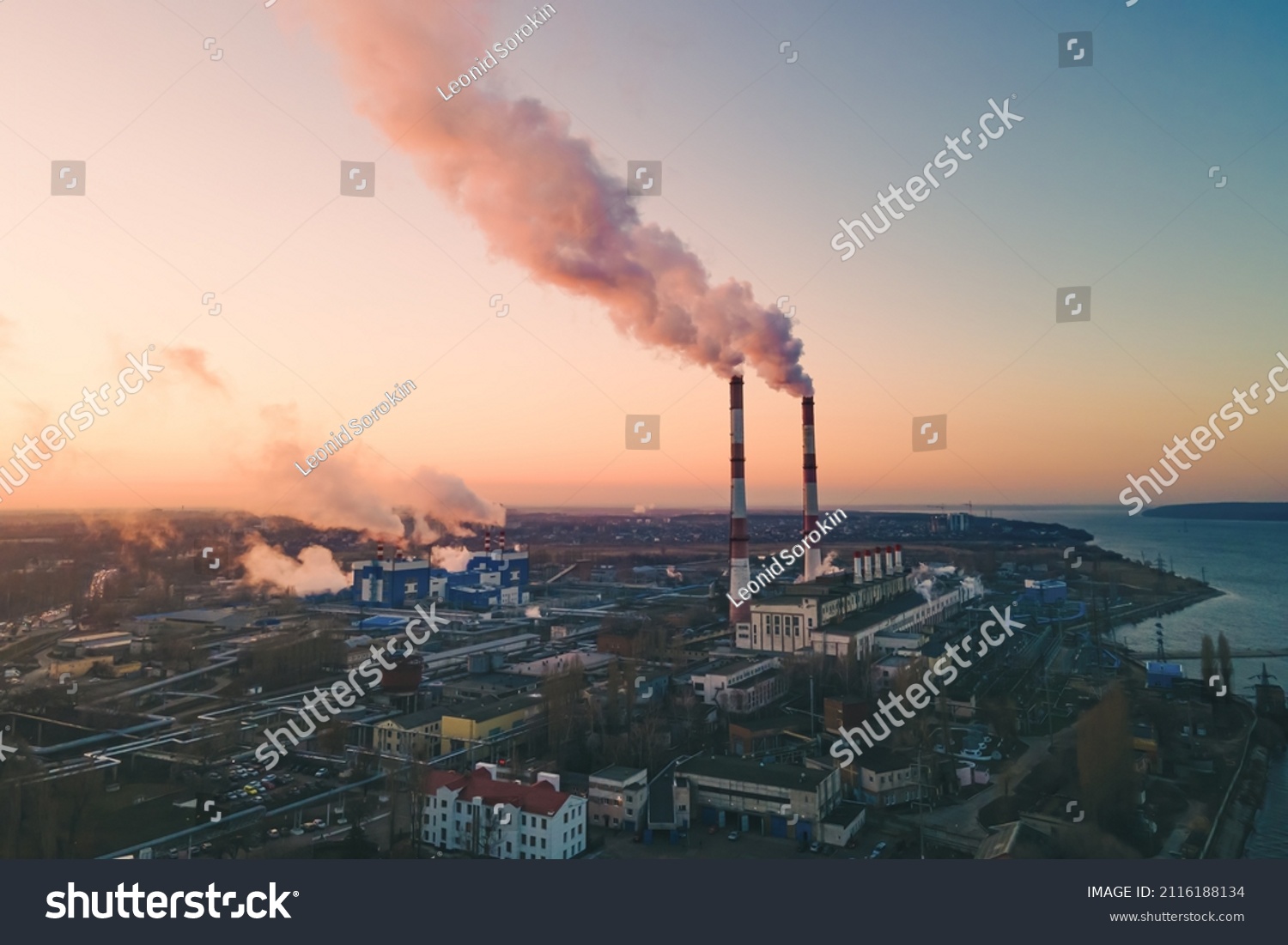 Air pollution by smoke of the factory smokestack in the industrial zone. Industrial plant pipe and Global warming concept #2116188134