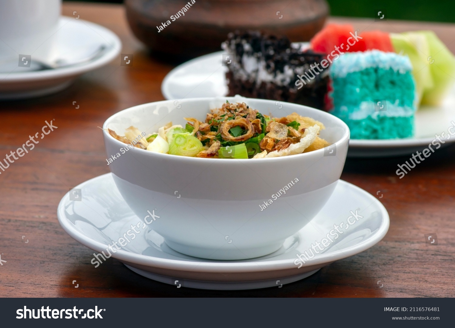 Close up of Bubur Ayam, chicken porridge, on wooden table #2116576481
