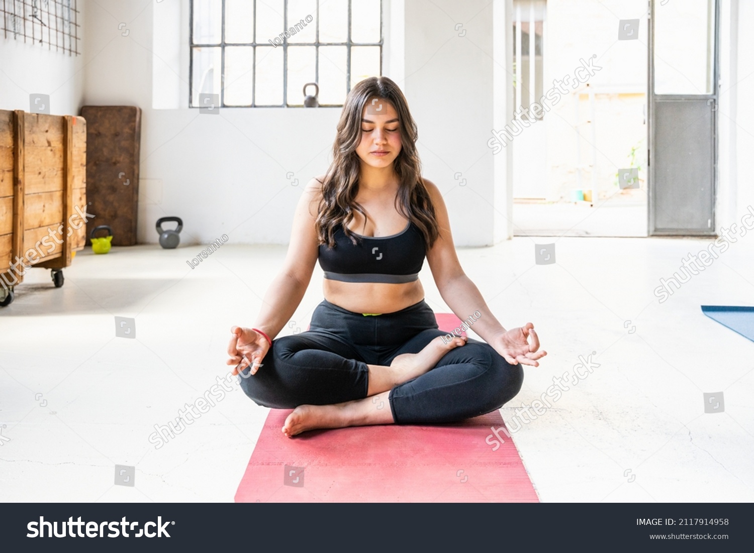 Beginner young beautiful young woman with sporty clothes does yoga exercises in the gym on the mat - Millennials trains with work out fitness for health - Concept of mental and physical well-being #2117914958