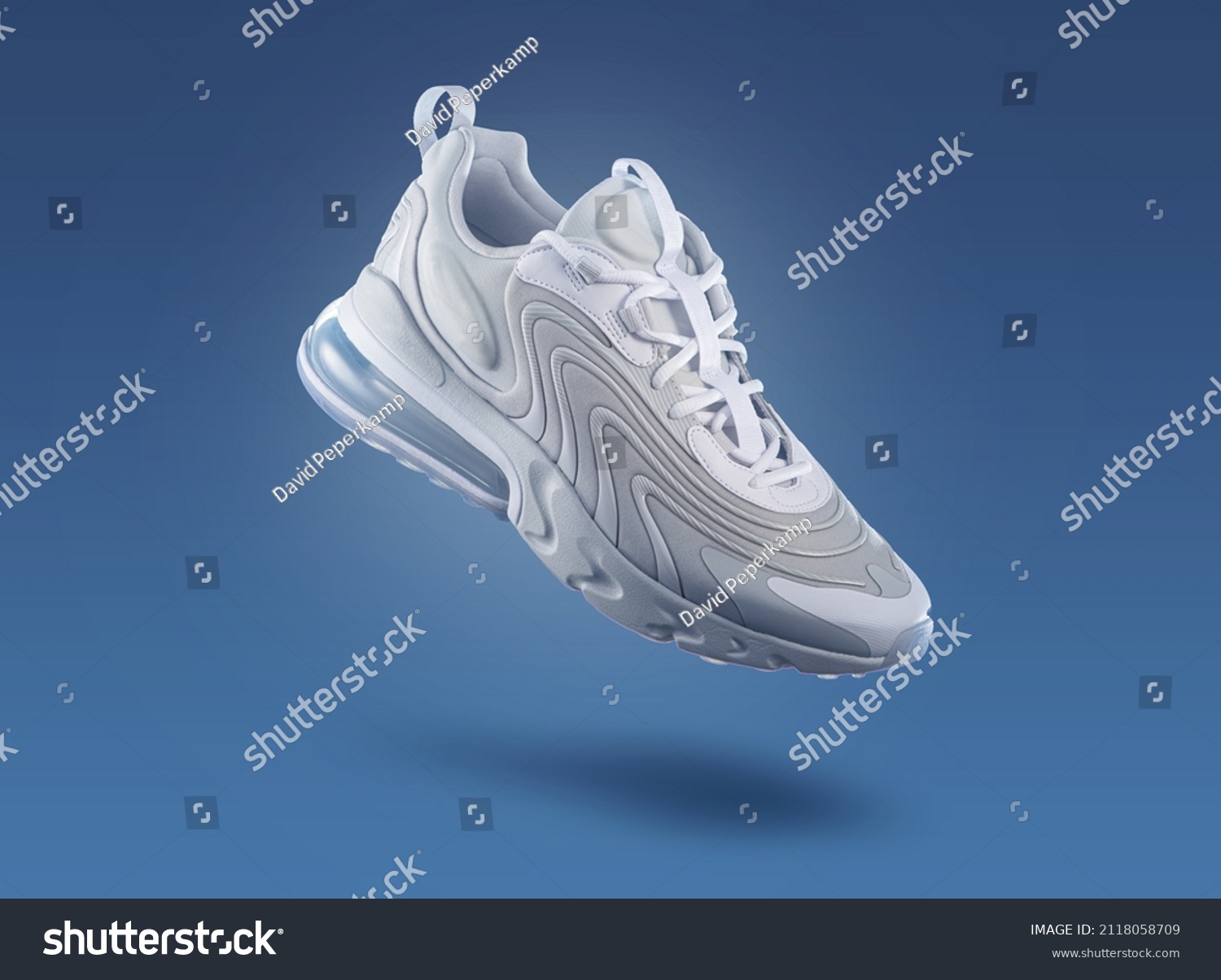 White sneaker on a blue gradient background, men's fashion, sport shoe,  air, sneakers, lifestyle, concept, product photo,  levitation concept, street wear, trainer #2118058709