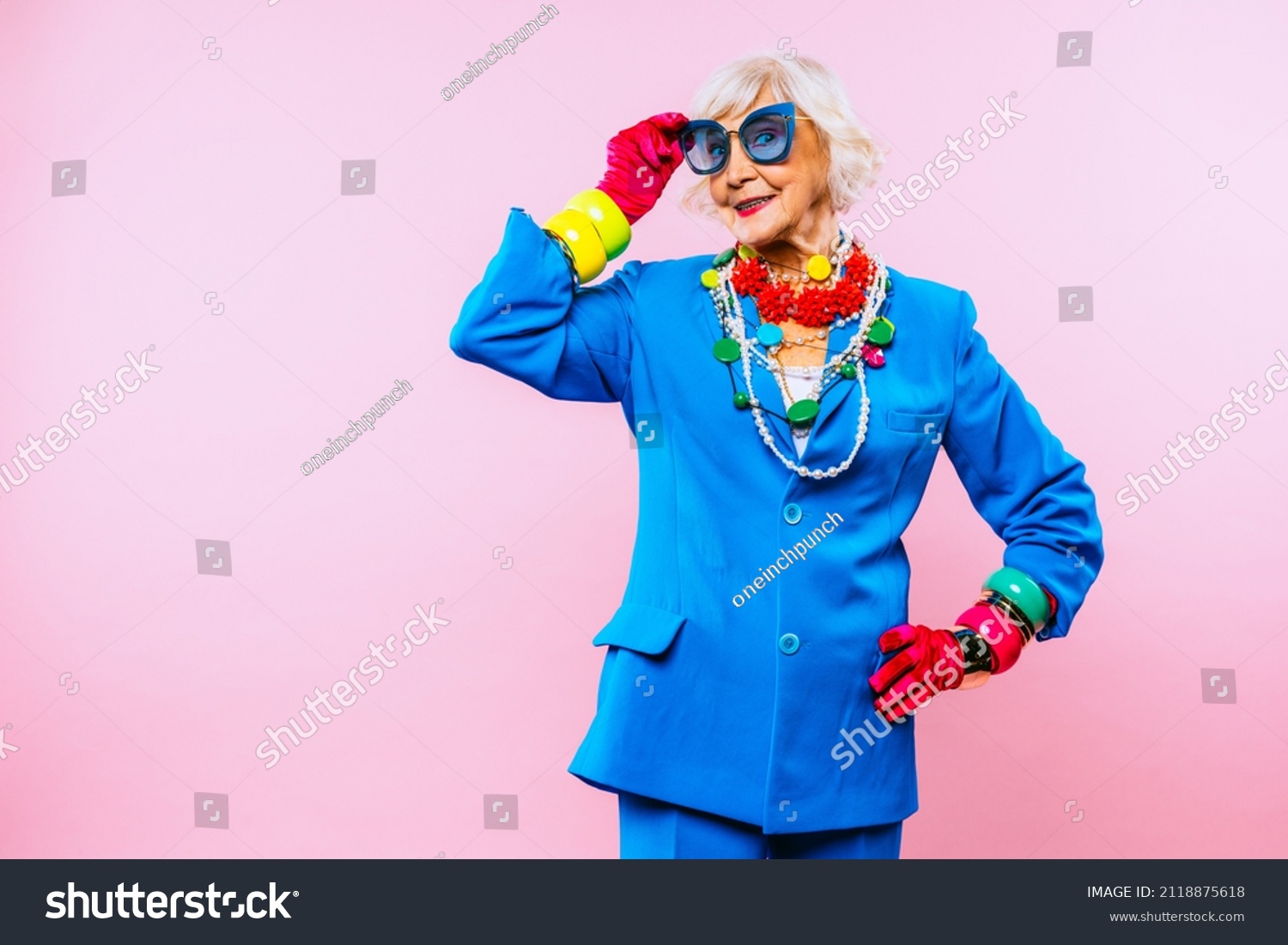Happy and funny cool old lady with fashionable clothes portrait on colored background - Youthful grandmother with extravagant style, concepts about lifestyle, seniority and elderly people #2118875618