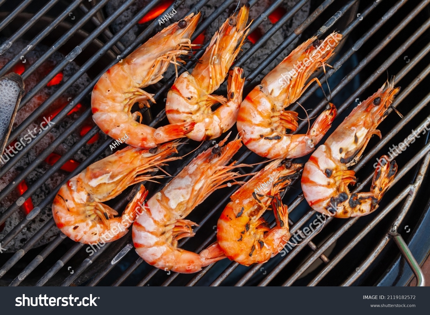 Grilled shrimp that's being cooked with smoke on the grill. #2119182572
