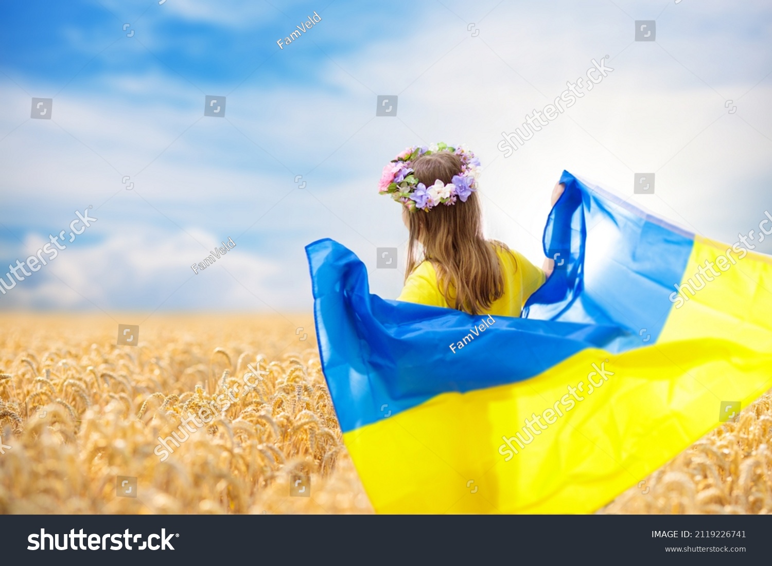 Pray for Ukraine. Child with Ukrainian flag in wheat field. Little girl waving national flag praying for peace. Happy kid celebrating Independence Day. #2119226741