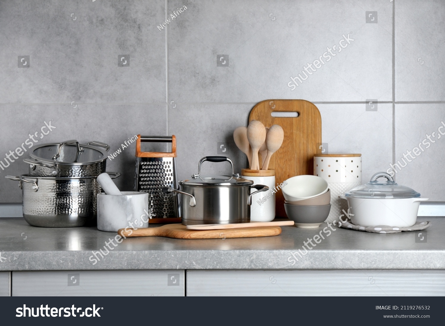 Set of different cooking utensils on grey countertop in kitchen #2119276532