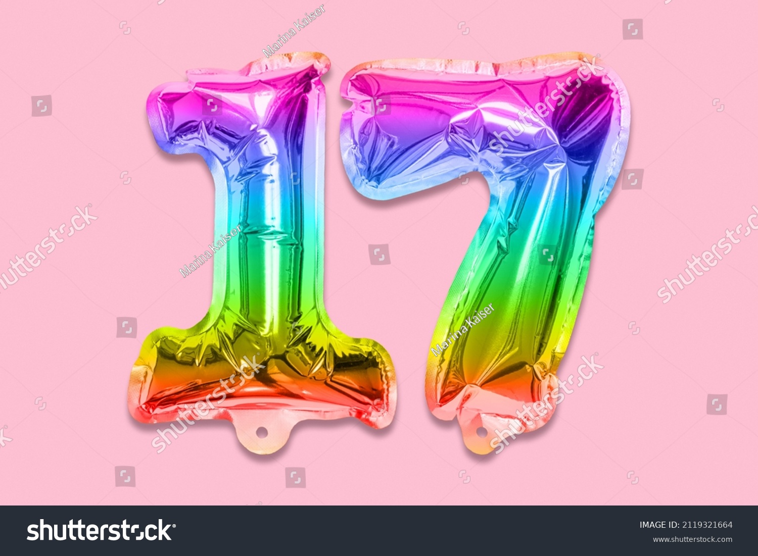 Rainbow foil balloon number, digit seventeen on a pink background. Birthday greeting card with inscription 17. Top view. Numerical digit. Celebration event, template. #2119321664