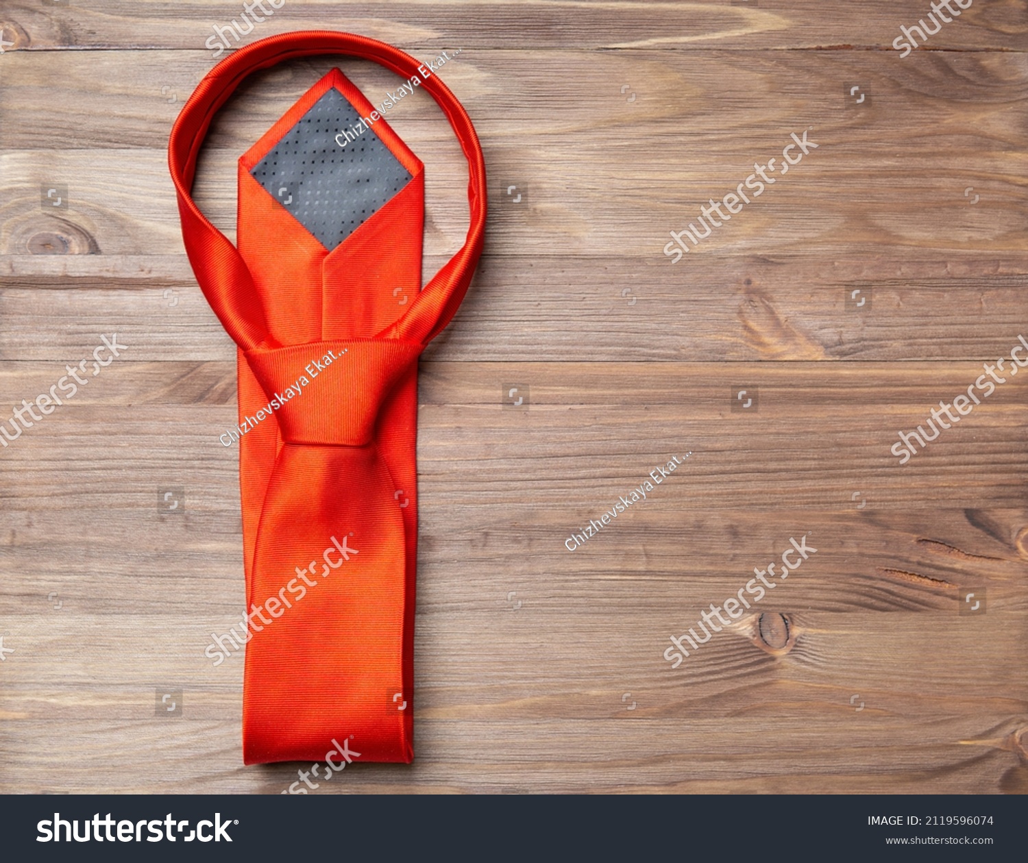 Stylish red necktie on a wooden background with copy space. #2119596074
