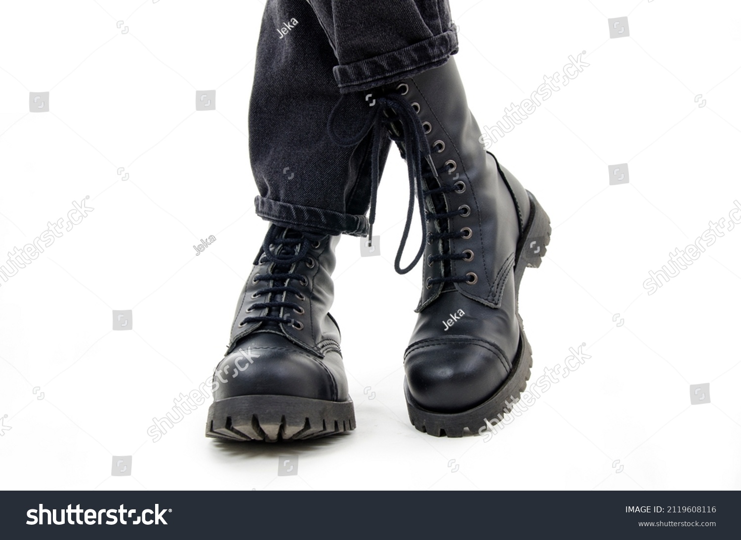 A woman standing in combat boots. Isolated on white background #2119608116