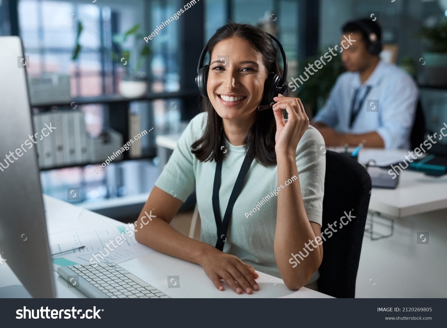 You havent heard quality until youve called us. Portrait of a young woman using a headset and computer in a modern office. #2120269805