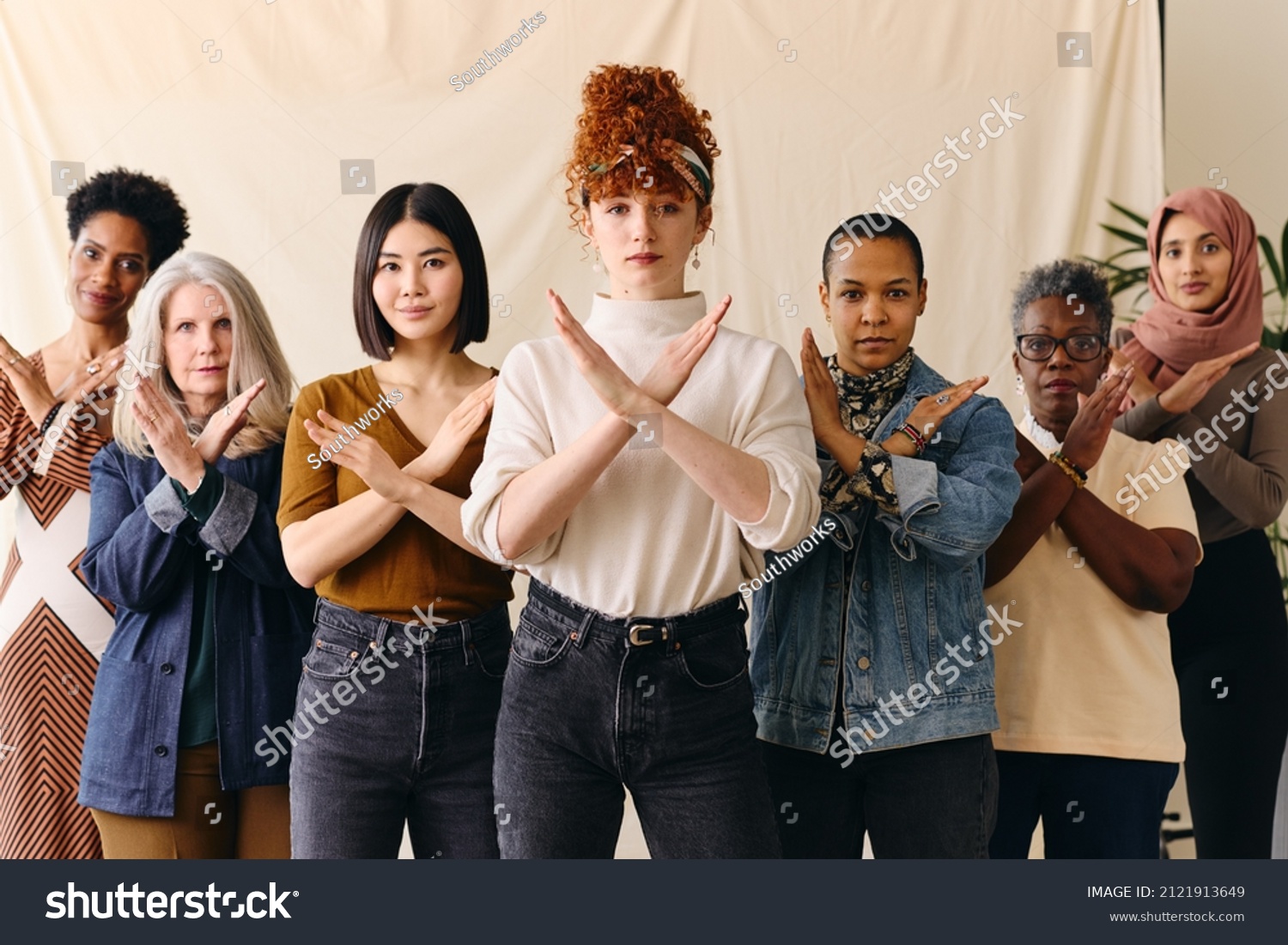 Young white woman gesturing Break The Bias in support of International Women's Day with female friends #2121913649