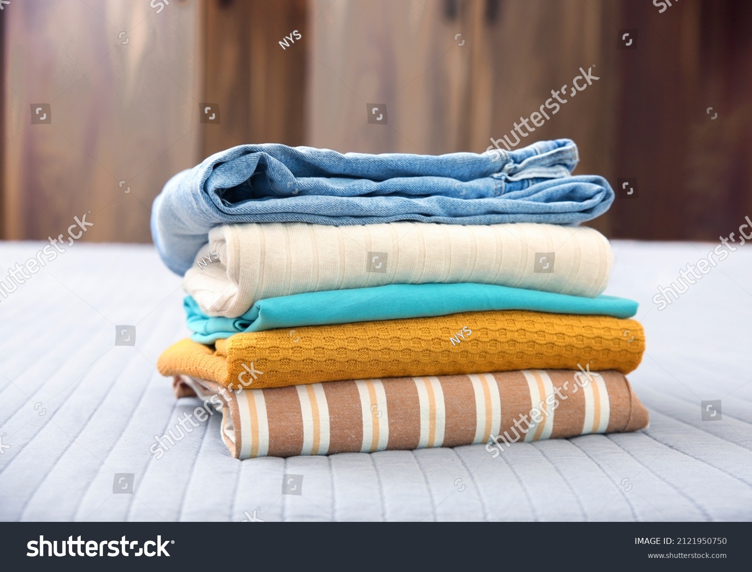 Stack of clothes. Pile of cotton garment.Folded clothing closeup. Laundry. #2121950750