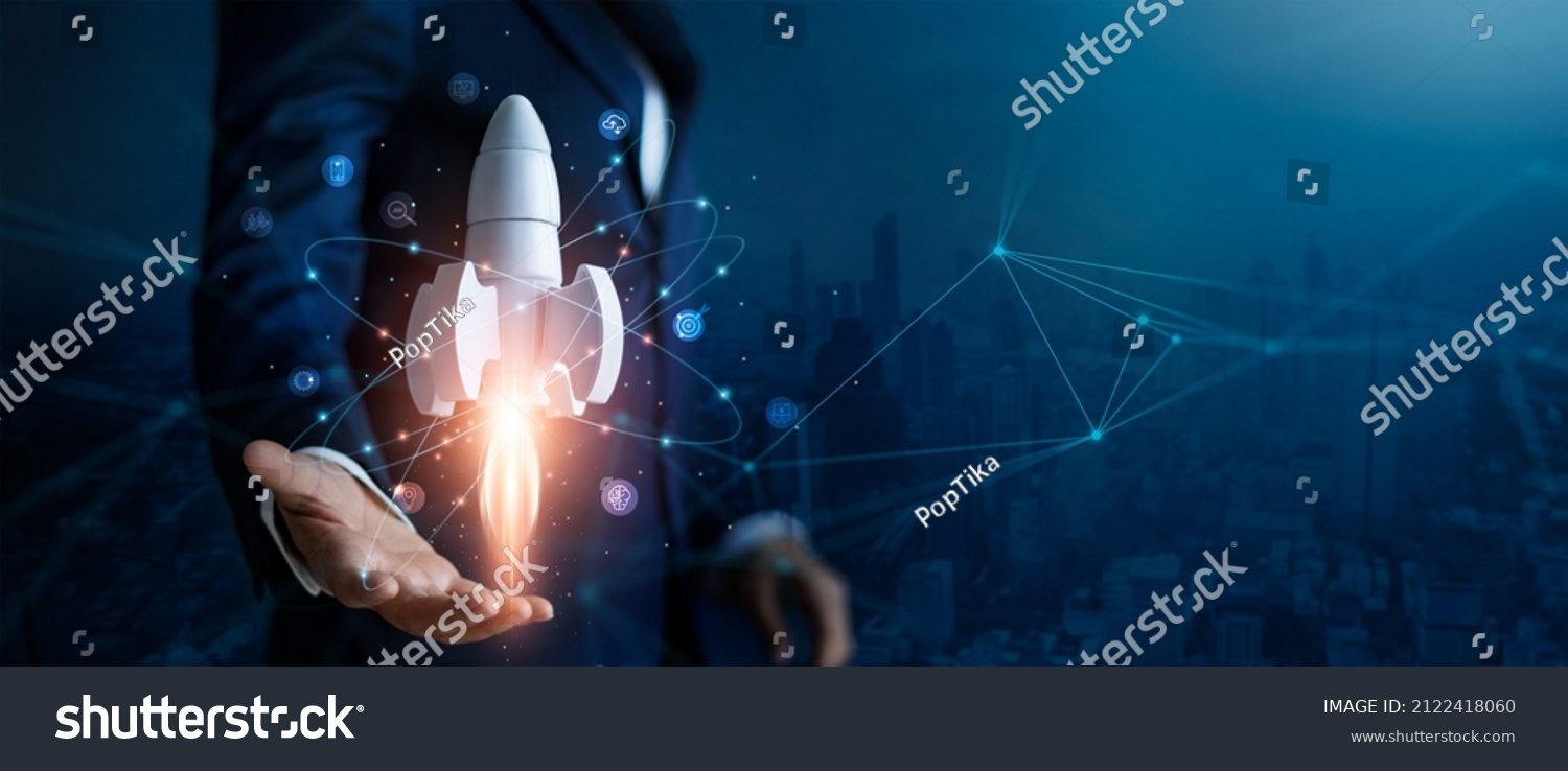 Startup business concept, Businessman control white rocket is launching and soar flying out from hand to sky for growth business,  Fast business success. Network connection on city background.  #2122418060