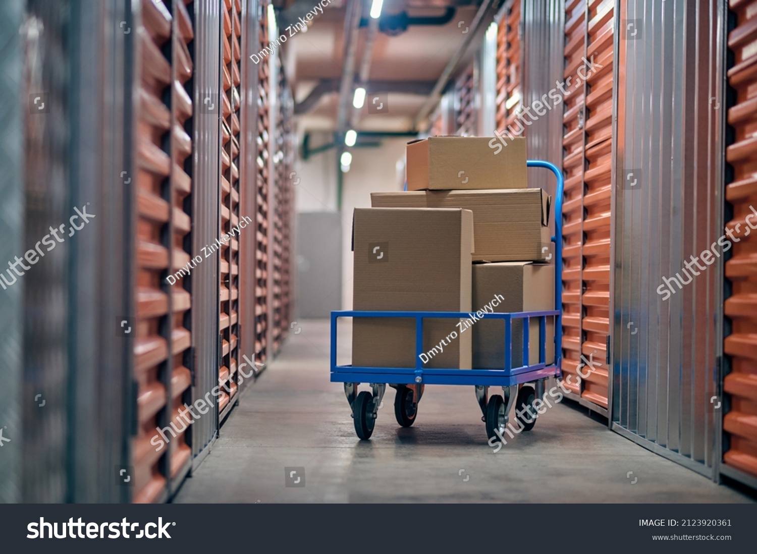 Stacked boxed goods lying on the hand truck #2123920361