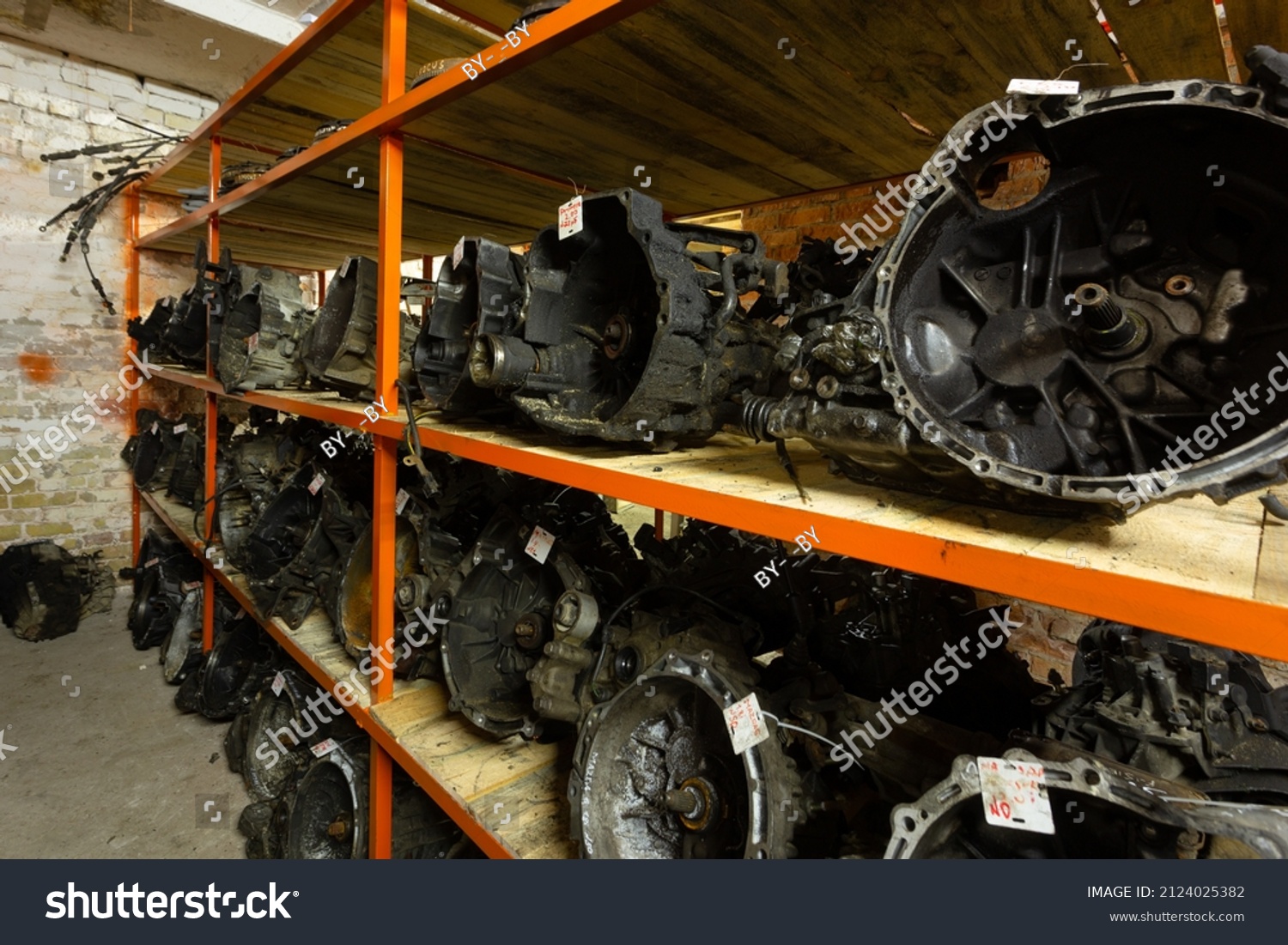 Used car parts on the store shelf. Used auto parts for sale in a store in a landfill. Transmissions for different kind of cars. Disassembly of cars. #2124025382