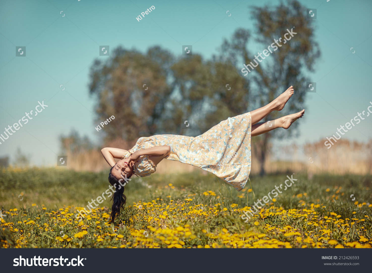 Girl floating in weightlessness over the meadow of dandelions. #212426593