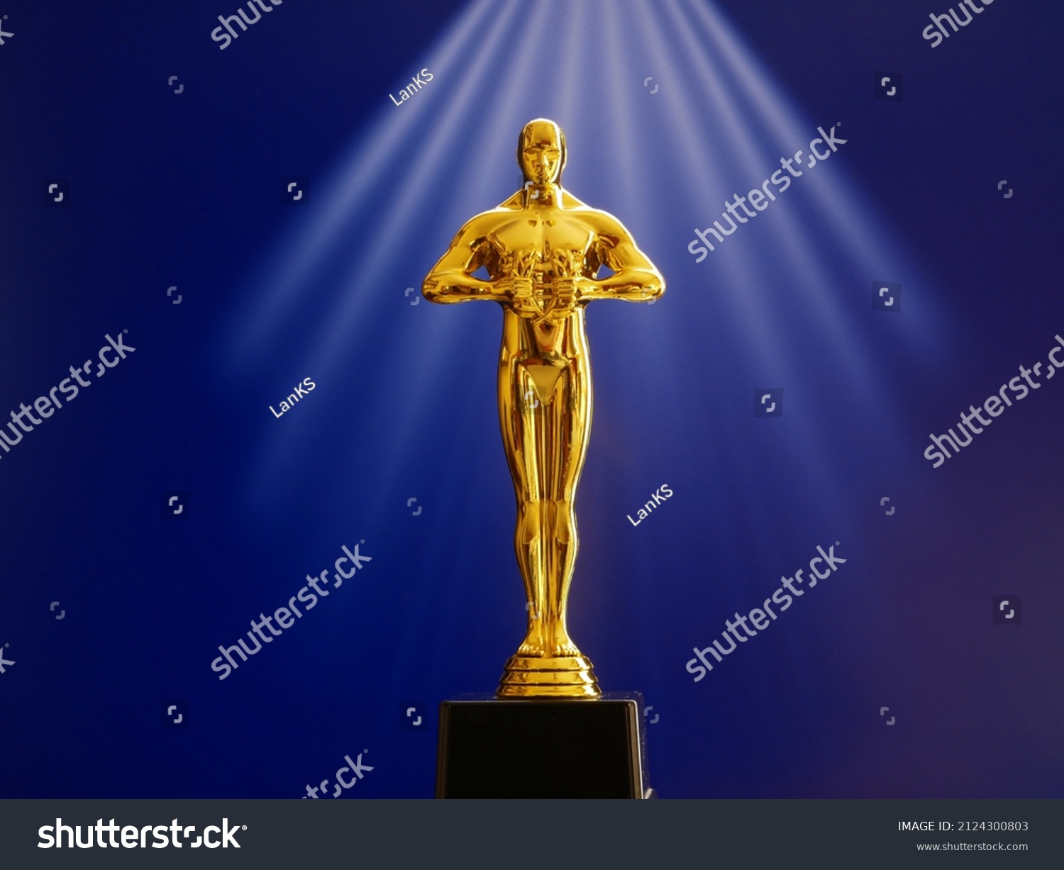 Hollywood Golden Oscar Academy award statue on red background. Success and victory concept. #2124300803