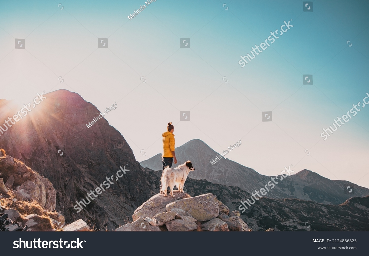woman with white dog sitting on mountain top in summer landscape slow travel and freedom concept #2124866825