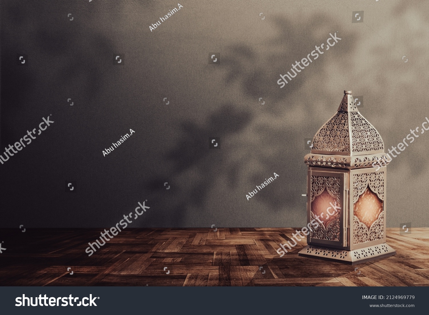 A lantern is placed on a wooden table with a beautiful background for the Muslim feast of the holy month of Ramadan Kareem. #2124969779