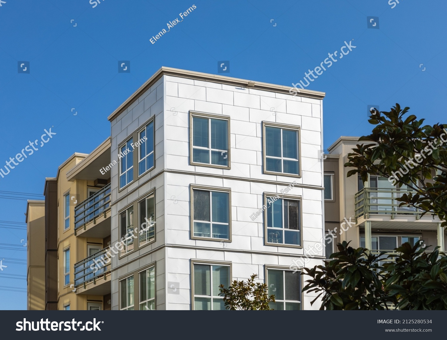 Brand new apartment building on sunny day in BC, Canada. Canadian modern residential architecture. Nobody, street photo #2125280534