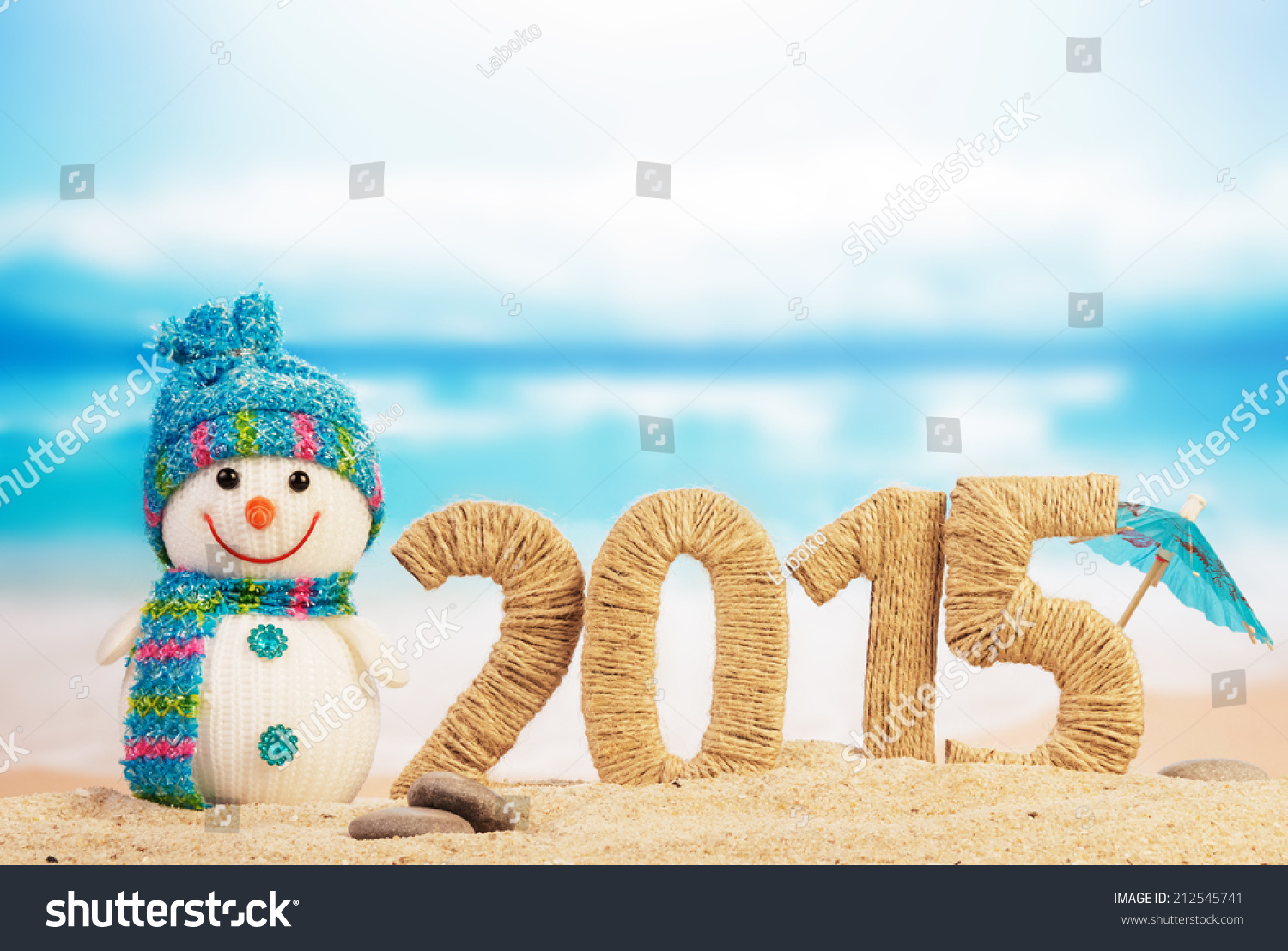 New year 2015 sign with snowman on beach background #212545741