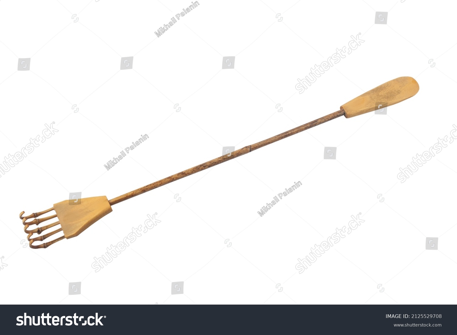 bamboo back scratcher is isolated on a white background. #2125529708