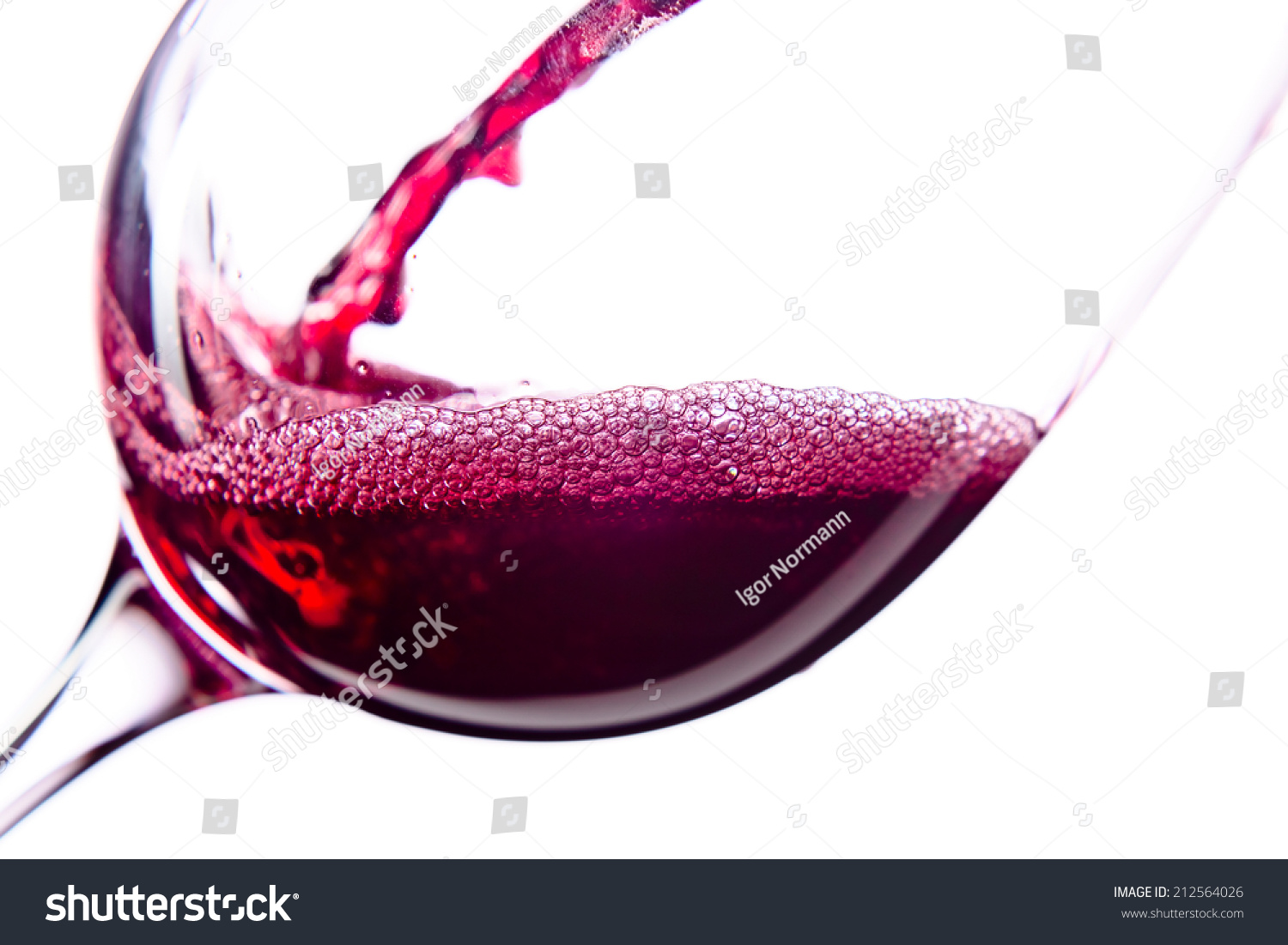  Red wine in wineglass on white background #212564026